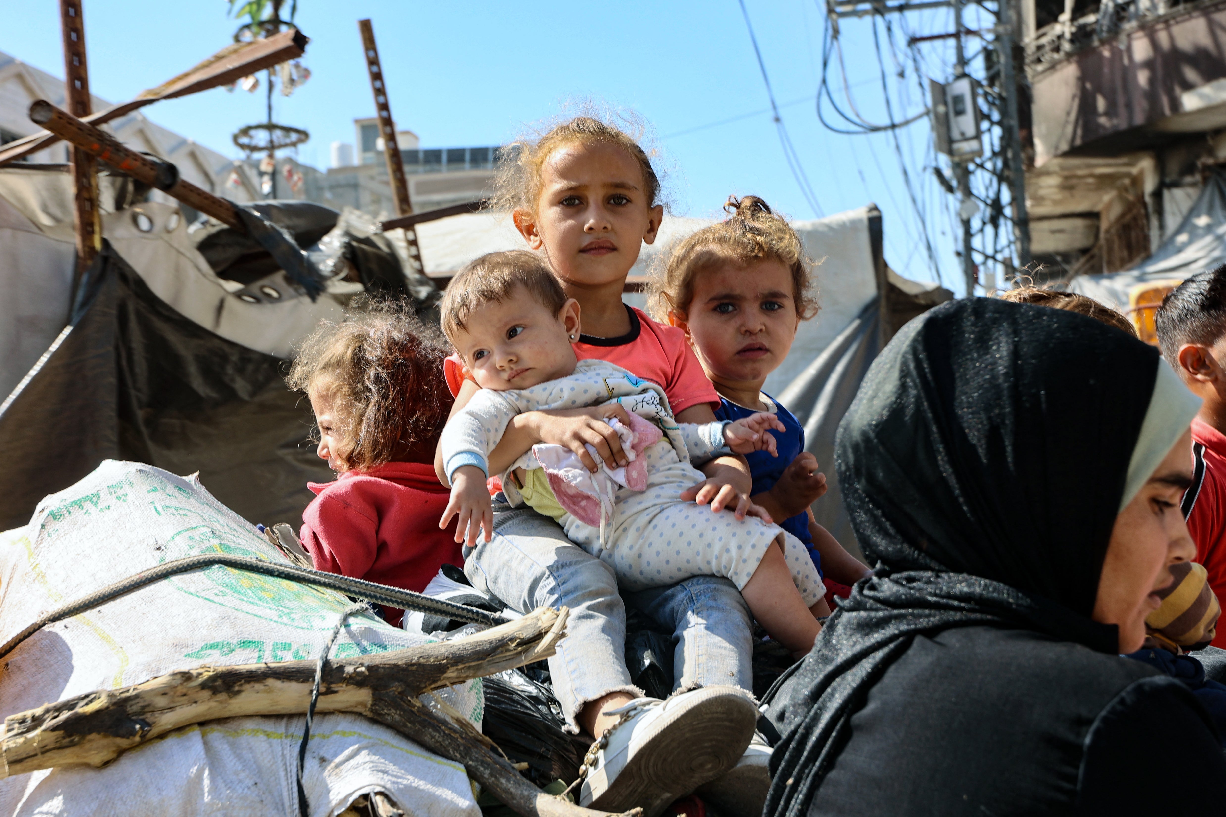 Palestinian children sitting on top of rubble at Jabalia refugee camp