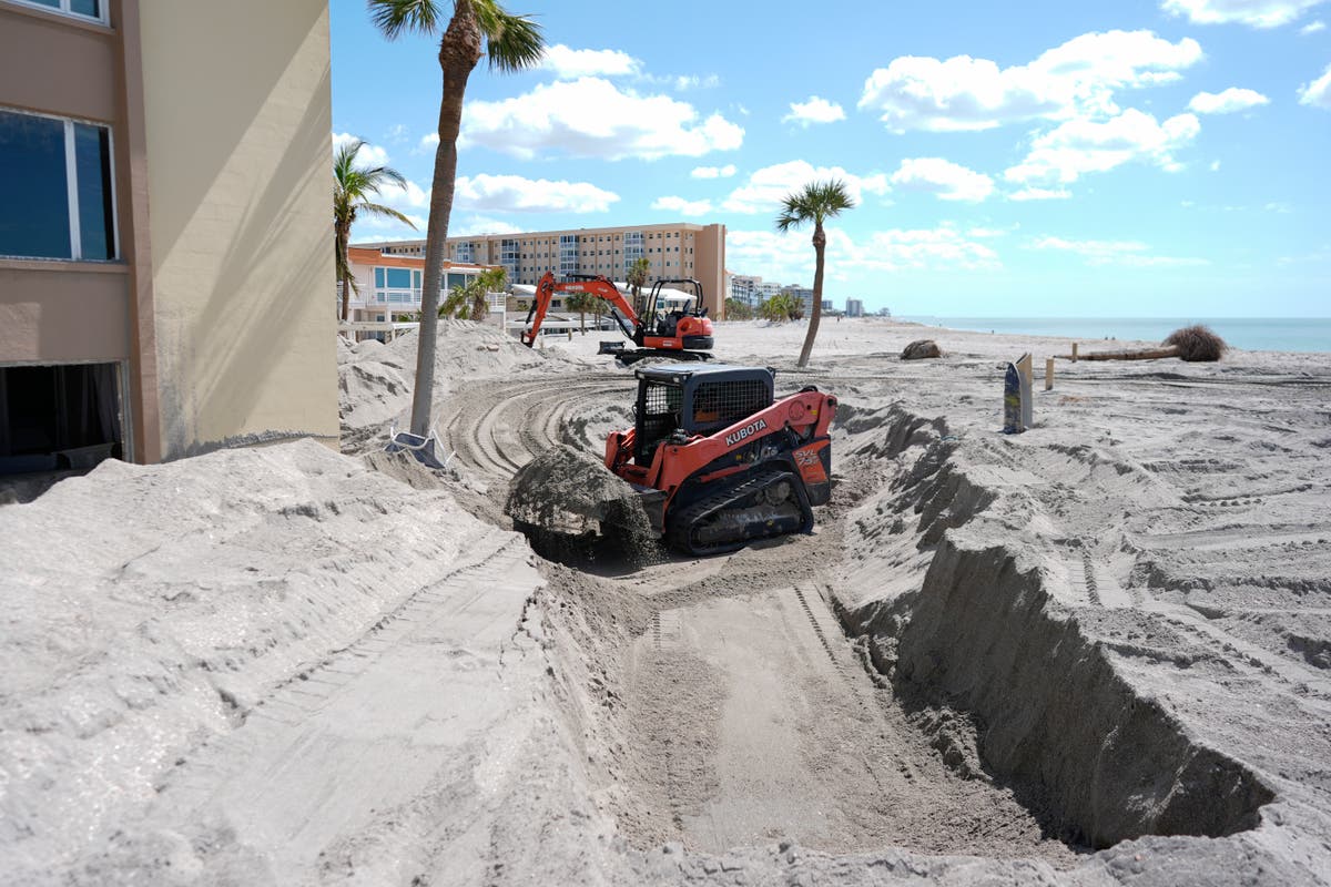 Florida digs out of mountains of sand swept in by back-to-back hurricanes