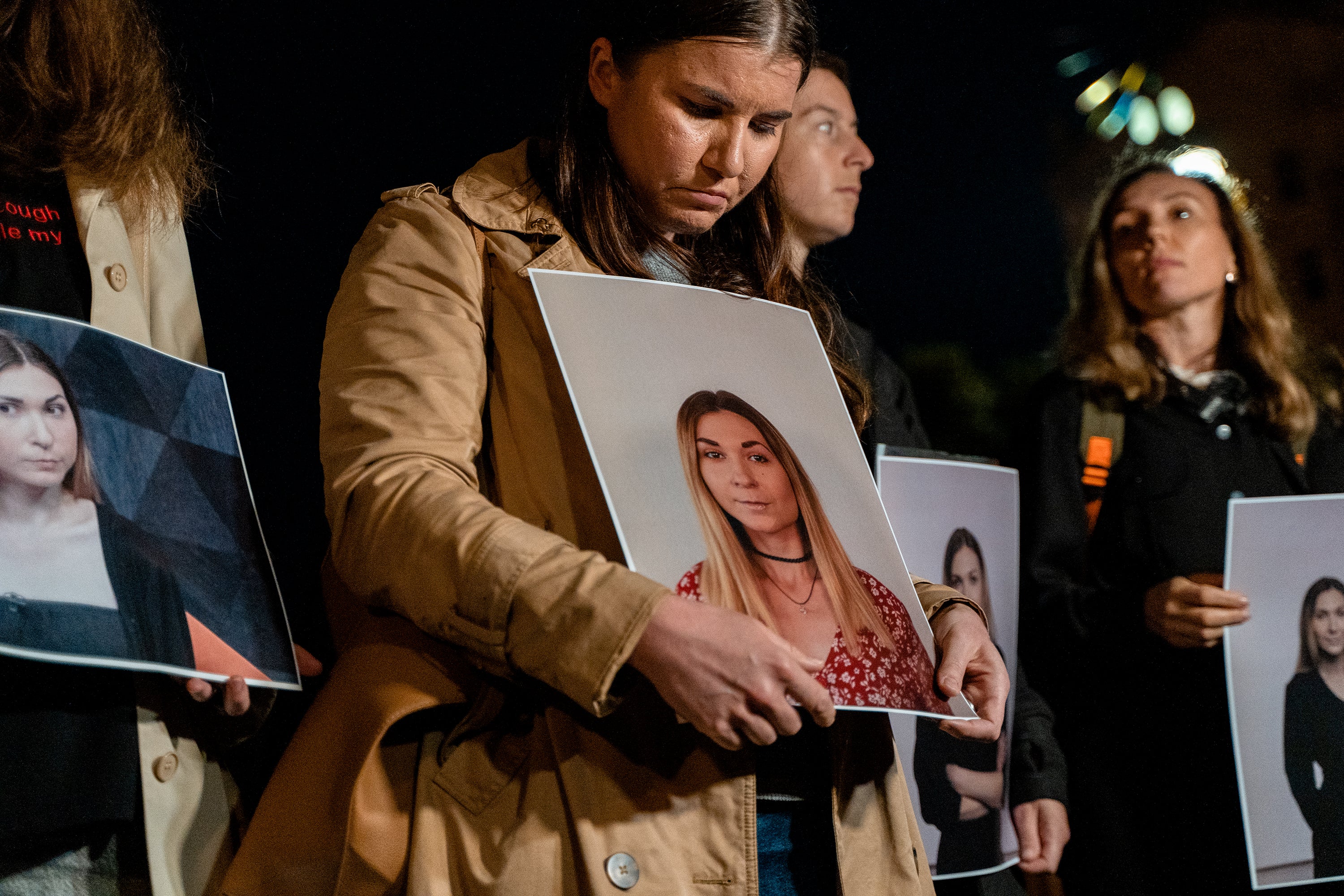 People hold portraits of Ukrainian journalist Victoria Roshchyna during a commemoration for Roshchyna who died in Russian captivity, on Maidan Nezalezhnosti (Independence Square)