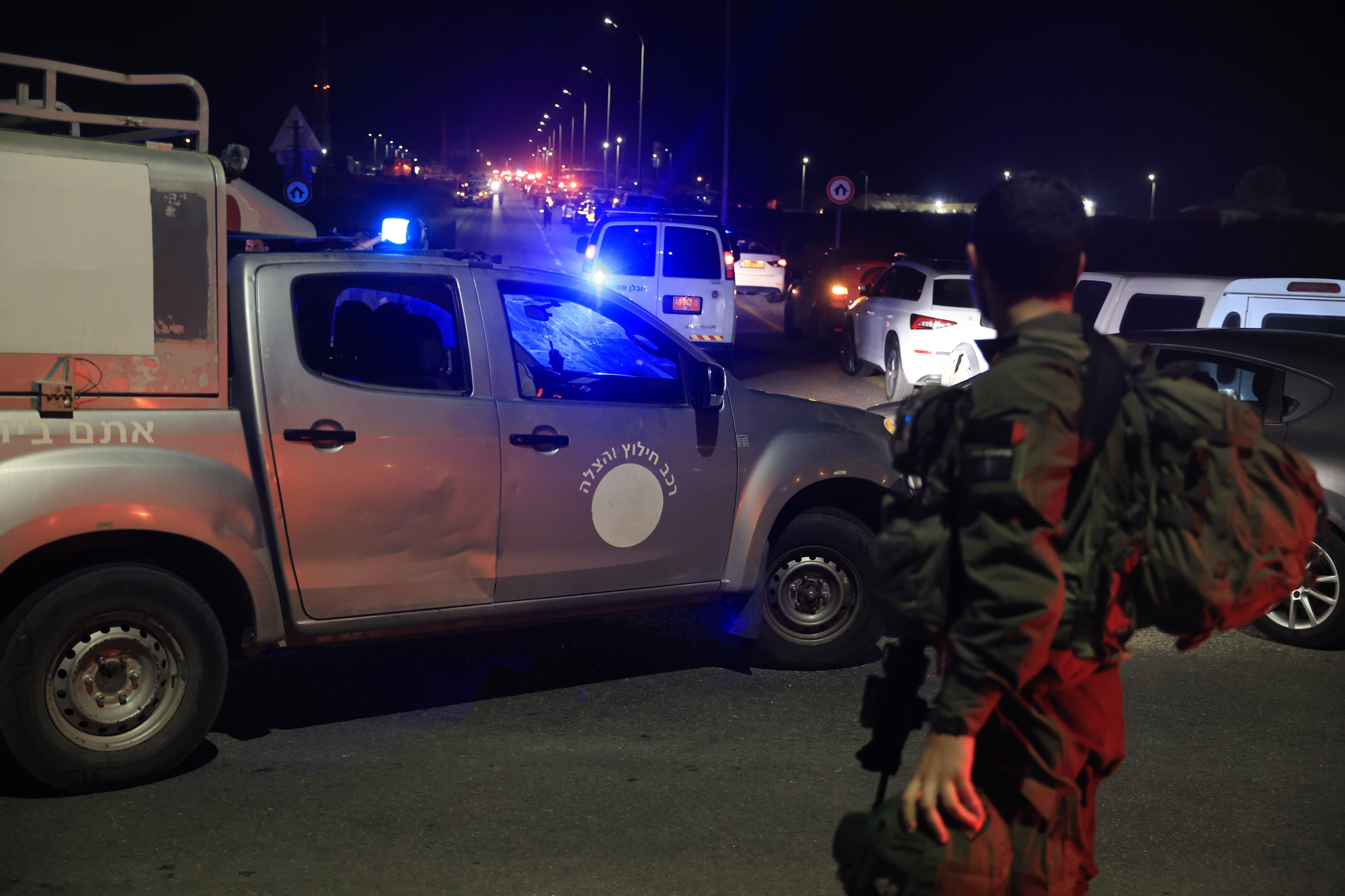 Emergency service personnel attend the scene of a drone strike in Binyamin, Israel on Sunday