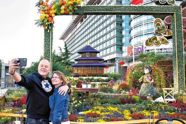 <p>A foreign couple take a selfie at a scenic spot in Beijing on 1 October</p>