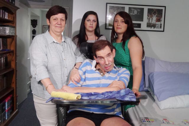 Tony Nicklinson with his wife Jane (left) and daughters Beth (right) and Lauren at home in Wiltshire as he suffered with locked-in syndrome (Emma Hallett/PA)