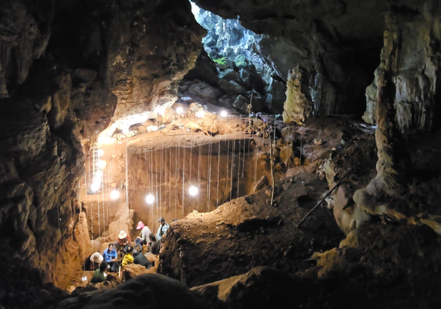 <p>Archaeologists excavating at Tam Pà Ling cave in Laos</p>