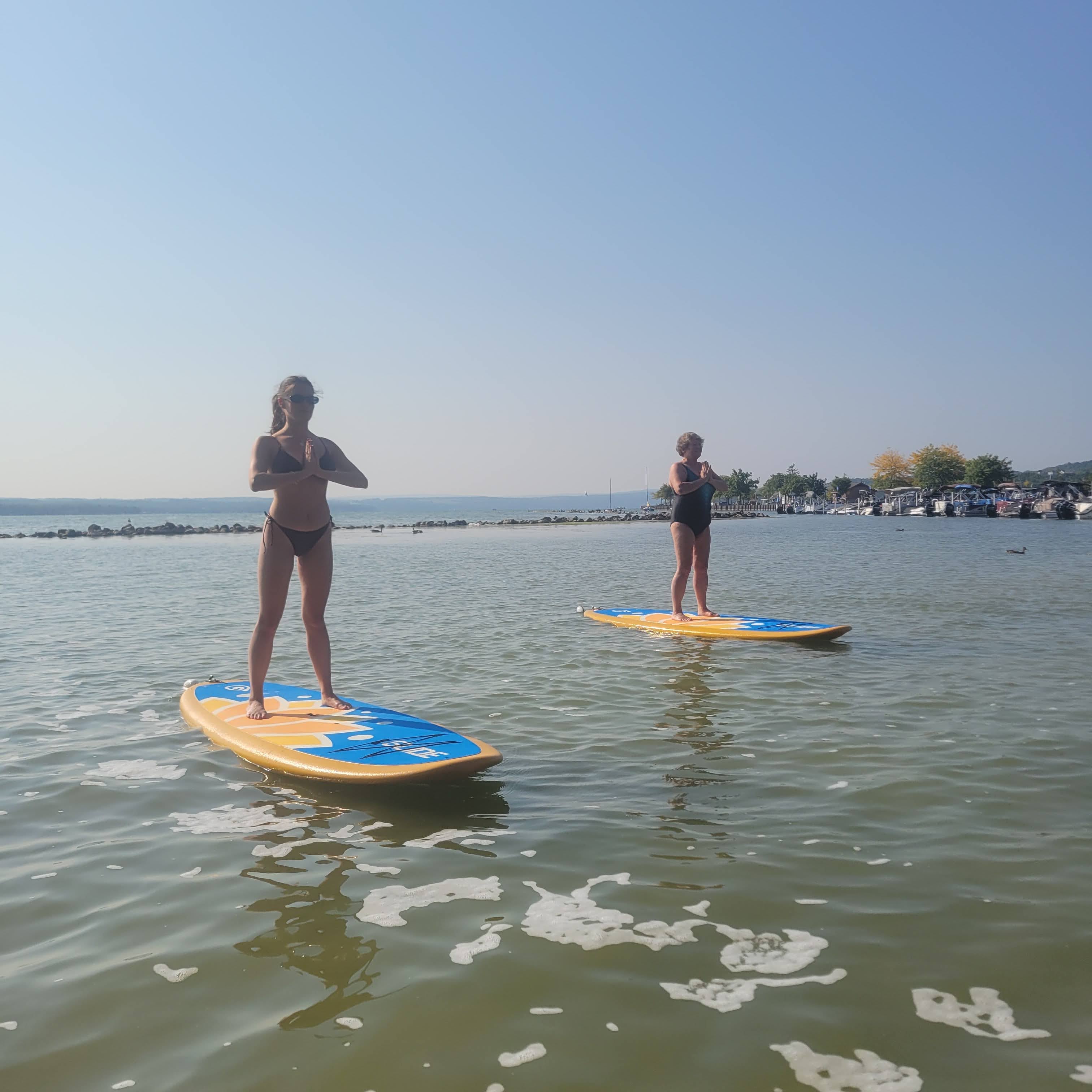 Taking part in a paddleboard yoga session on Canandaigua Lake