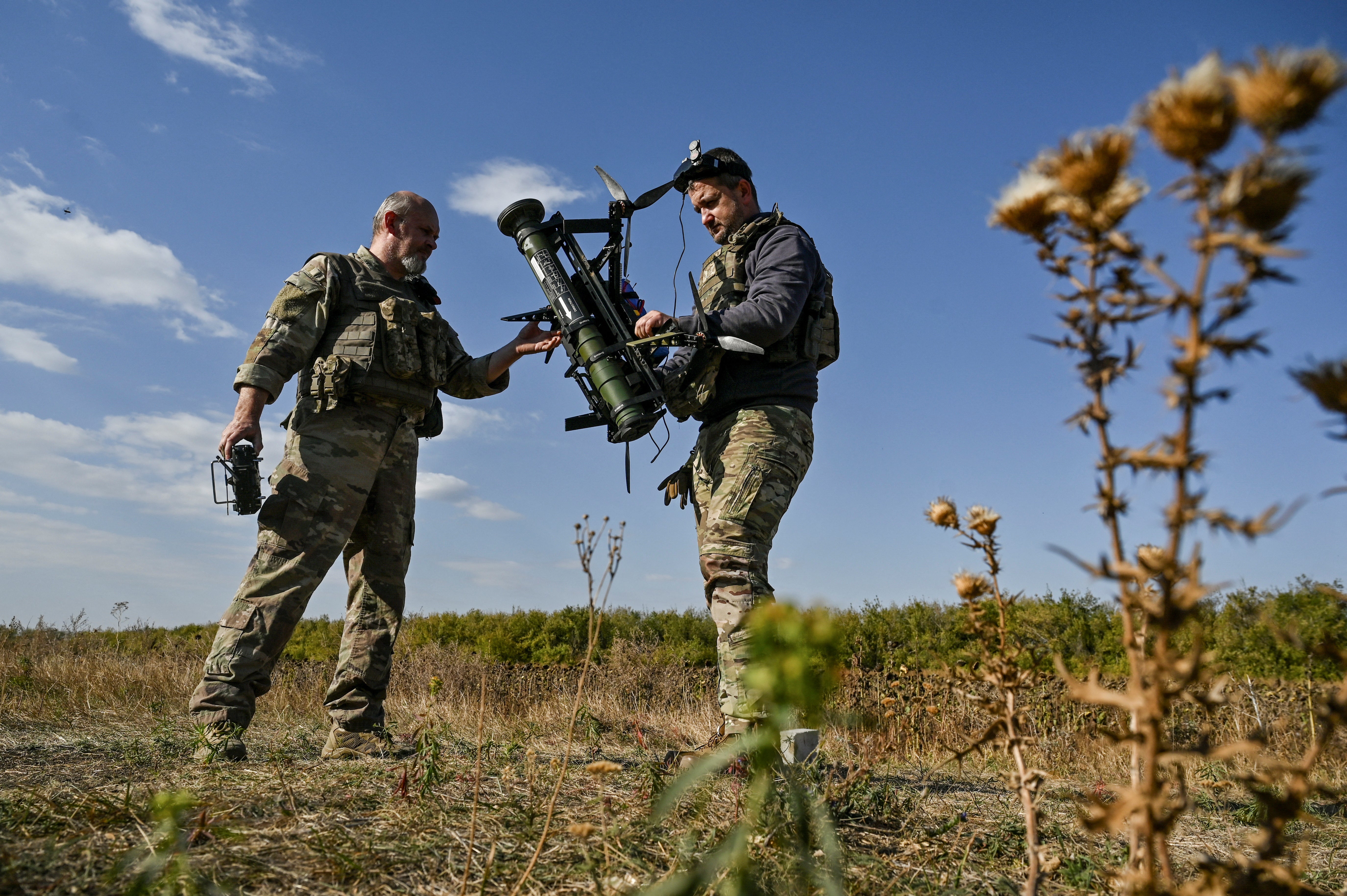 Ukrainian servicemen of the 'Bulava' Unmanned Aerial Vehicles Unit of the Separate Presidential Brigade prepare for a test fly an FPV drone with an attached portable grenade launcher at their position near a frontline, amid Russia's attack on Ukraine, in Zaporizhzhia region, Ukraine October 11, 2024. REUTERS/Stringer