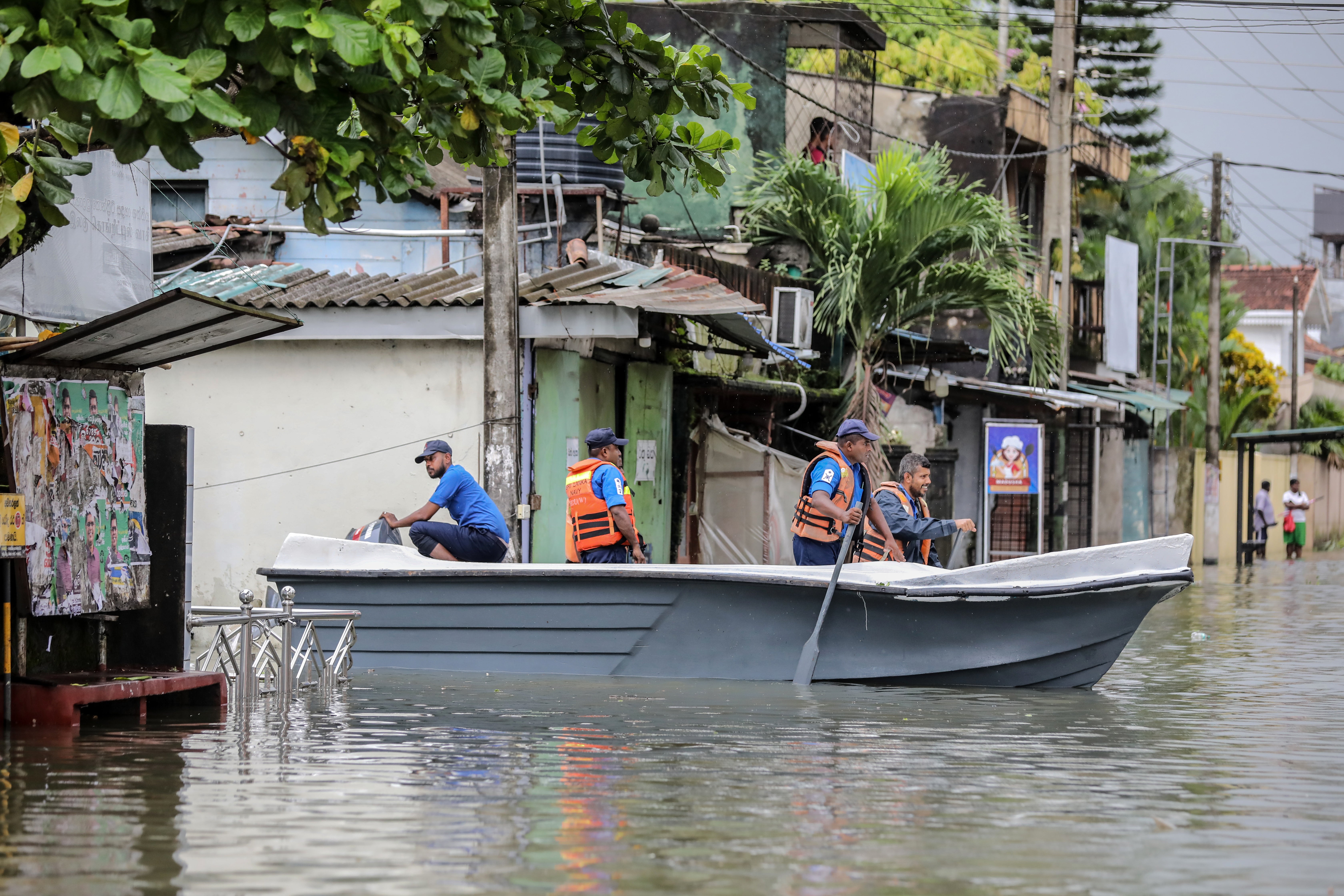 A Sri Lankan Navy rescue boat passes through a submerged road after heavy rainfall in Colombo