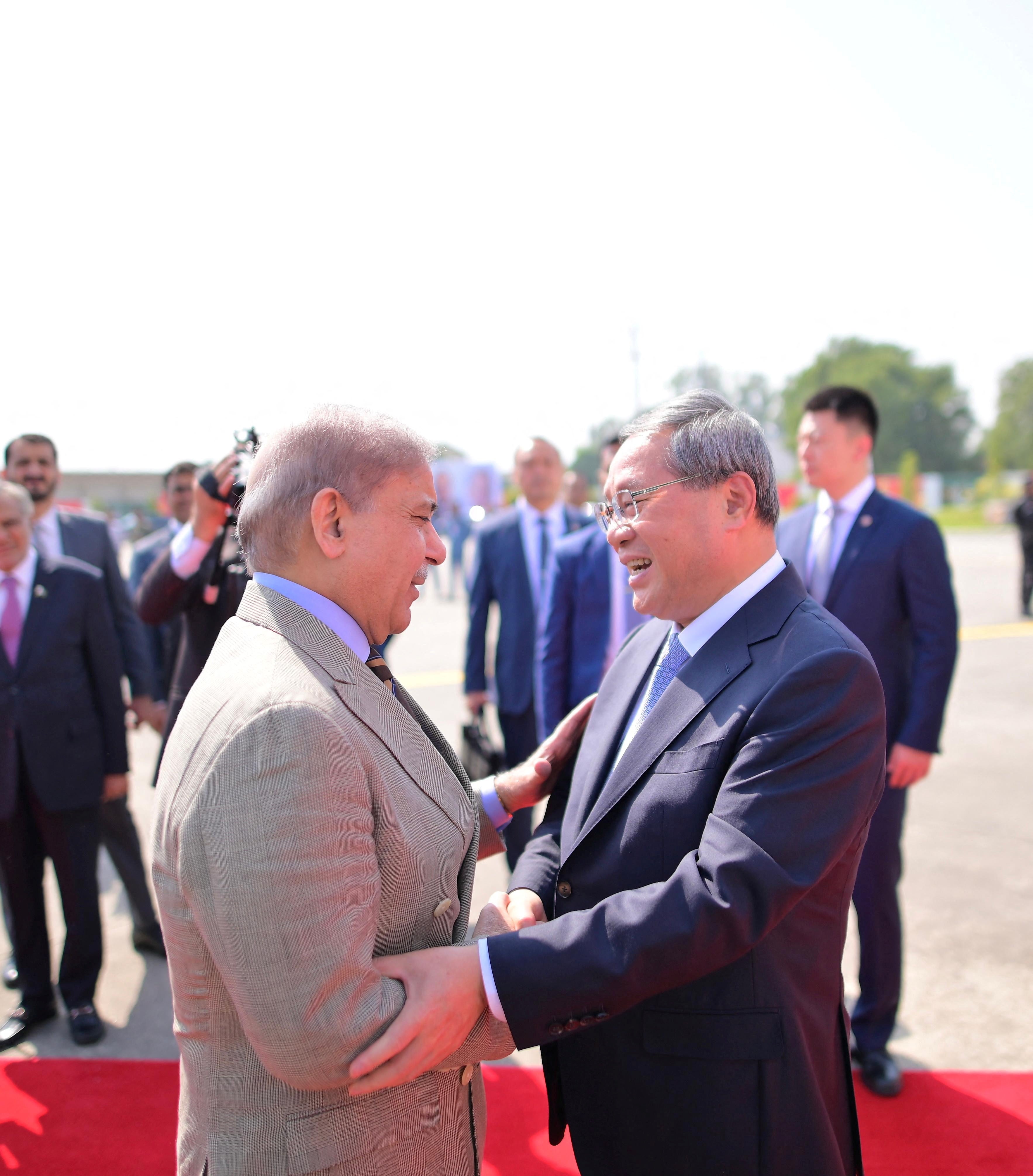 Prime Minister Shehbaz Sharif welcomes Chinese Premier Li Qiang upon his arrival to attend Shanghai Cooperation Organisation meeting in Islamabad