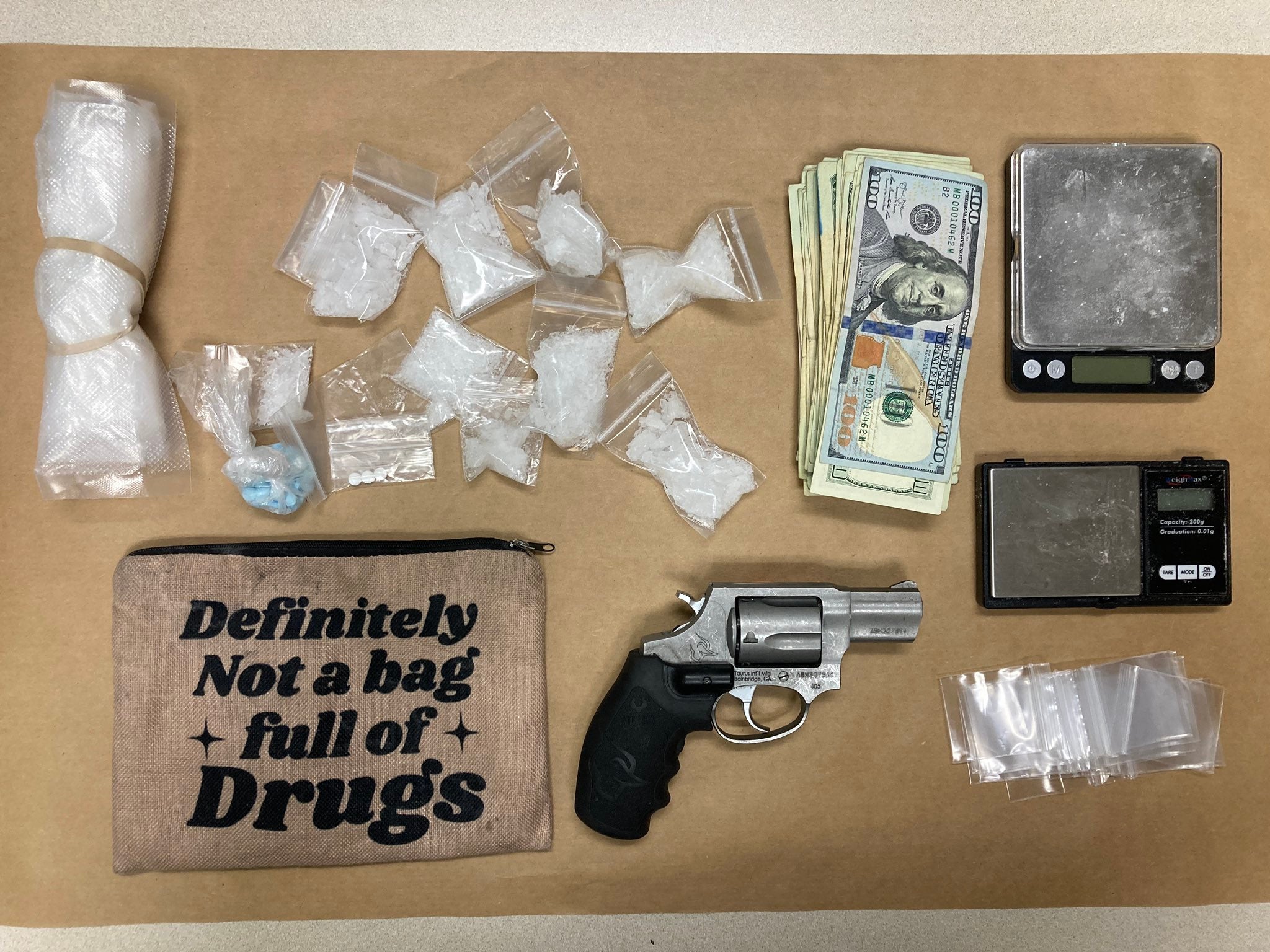 Drugs , cash, a loaded weapon and scales were found in the Ford Taurus last week