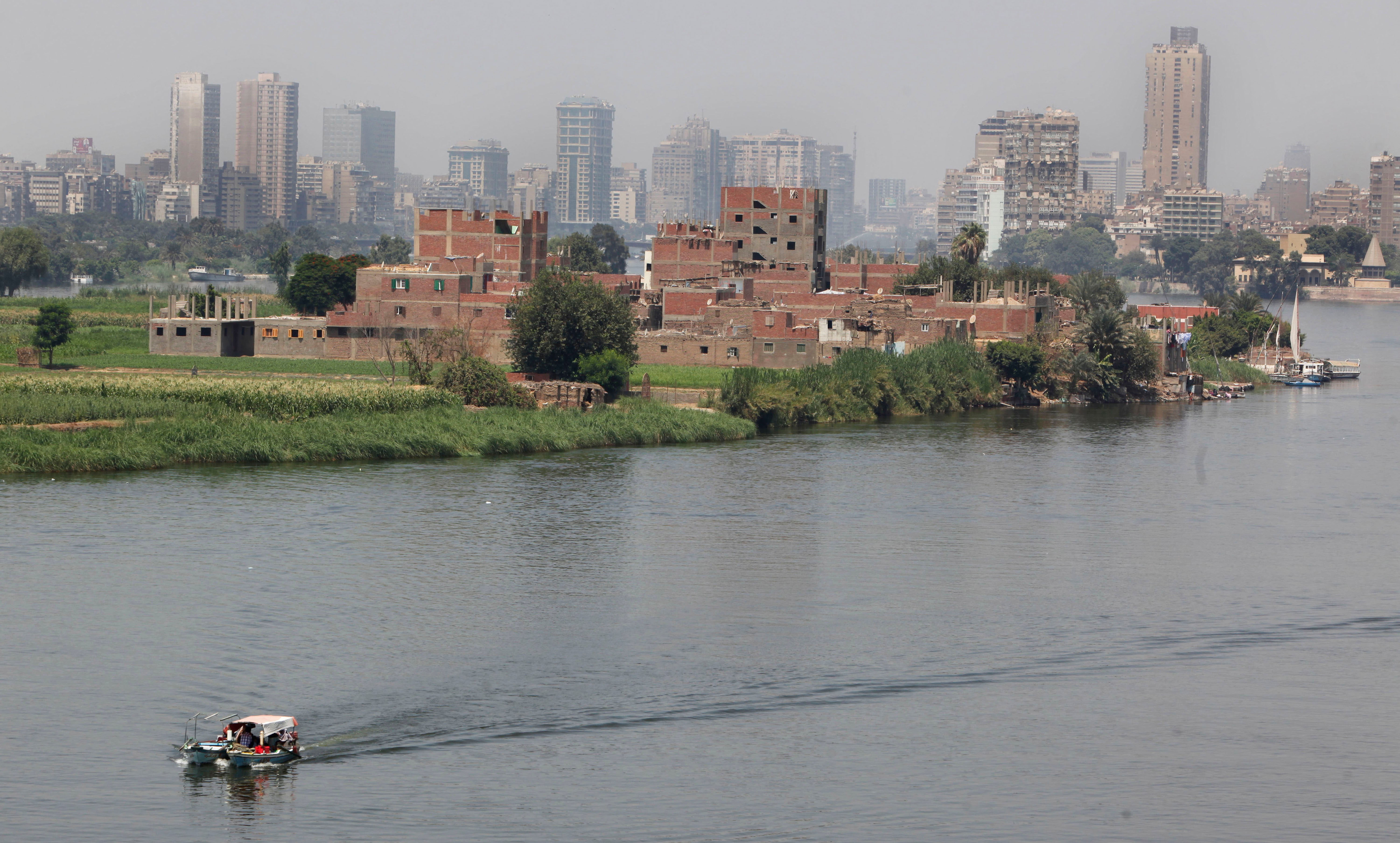 A fisherman's boat sails along the River Nile in Cairo, Egypt