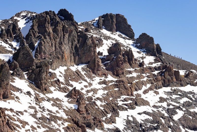 Ground crews climb the southwest ridge of Eagle Peak for Austin