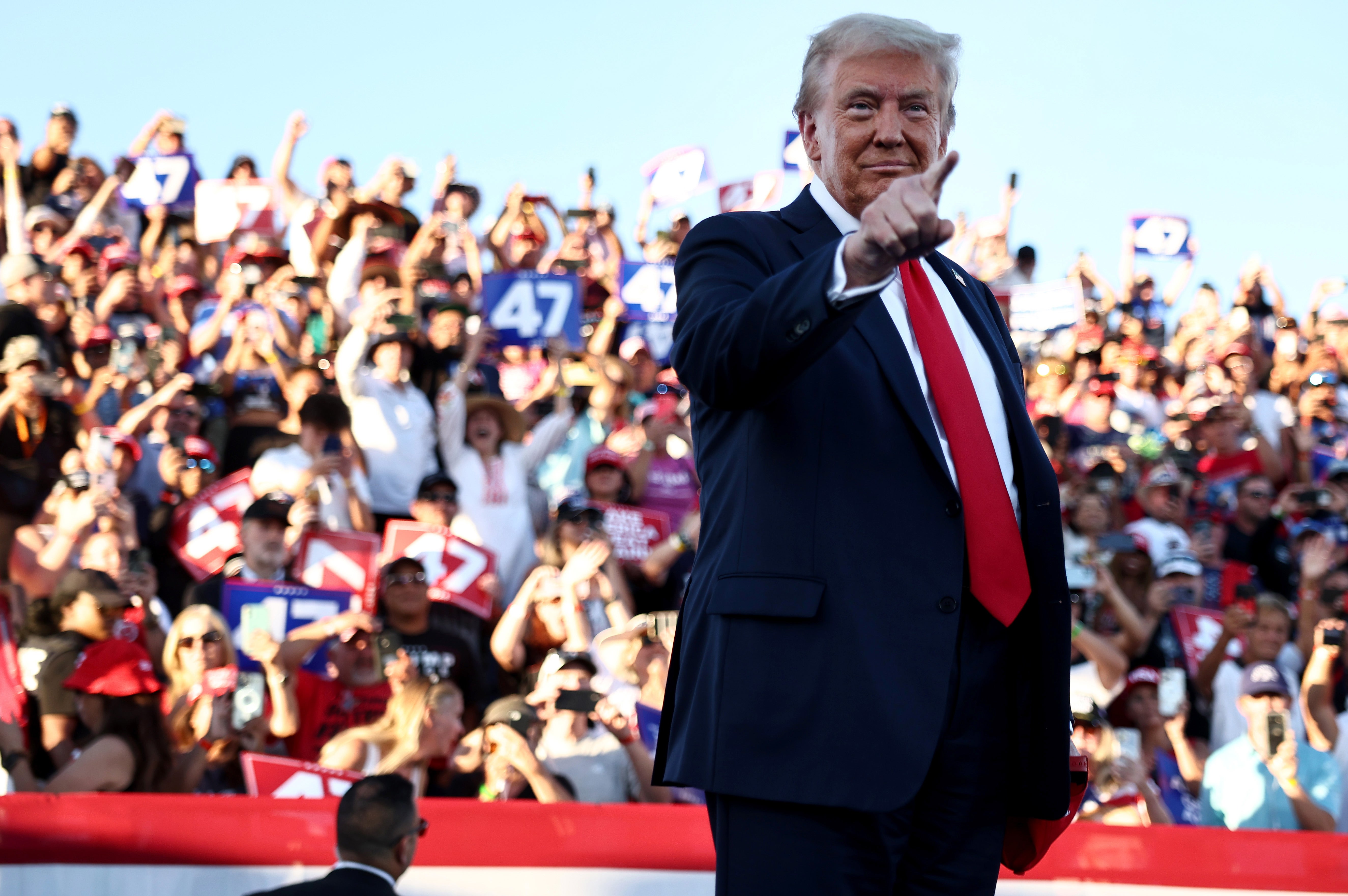 Trump gestures as he takes the stage for a campaign rally on October 12, 2024 in Coachella, California