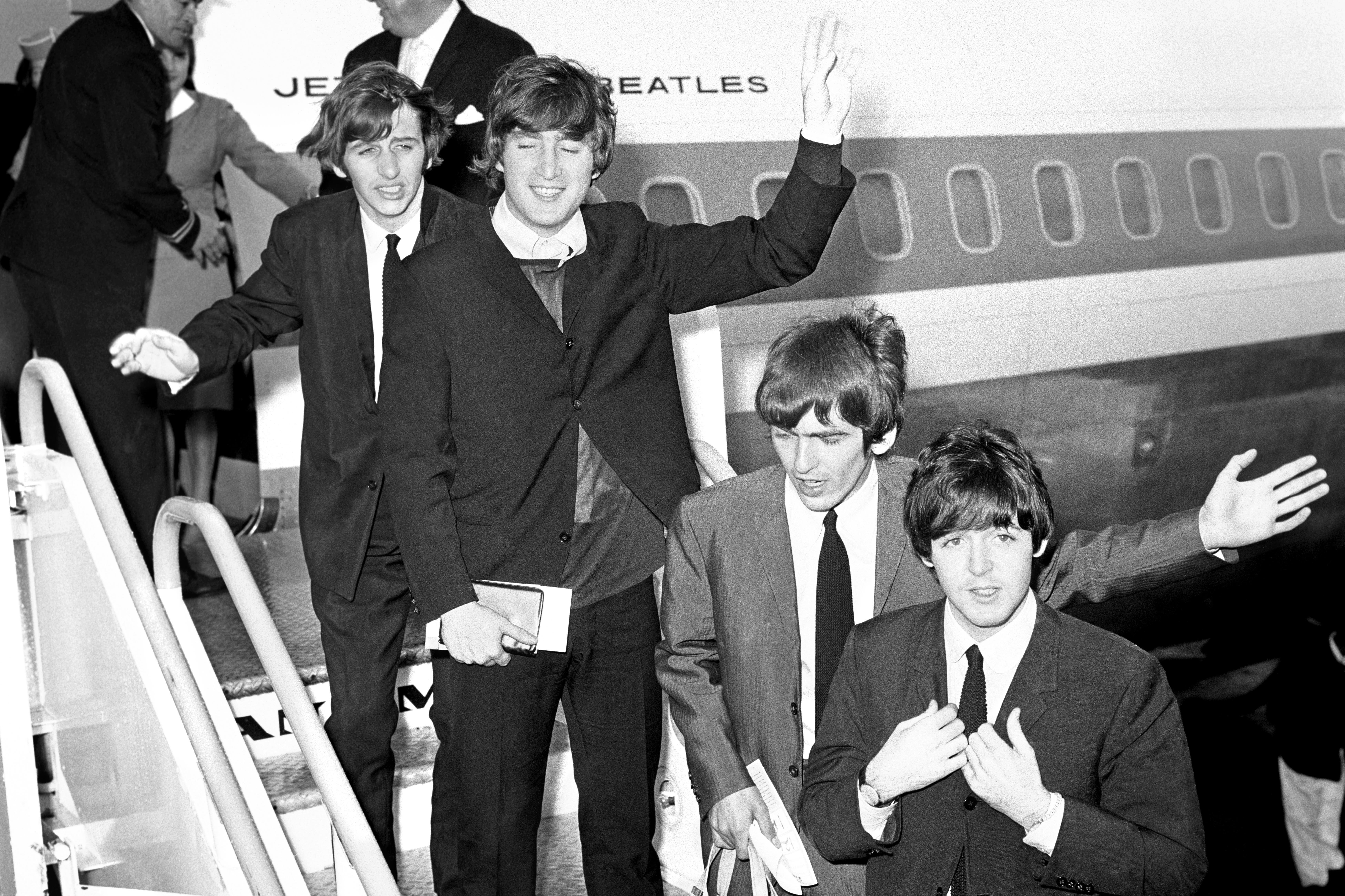 Ringo Starr, John Lennon, George Harrison, and Paul McCartney board a plane at Heathrow Airport for their tour of America (PA)