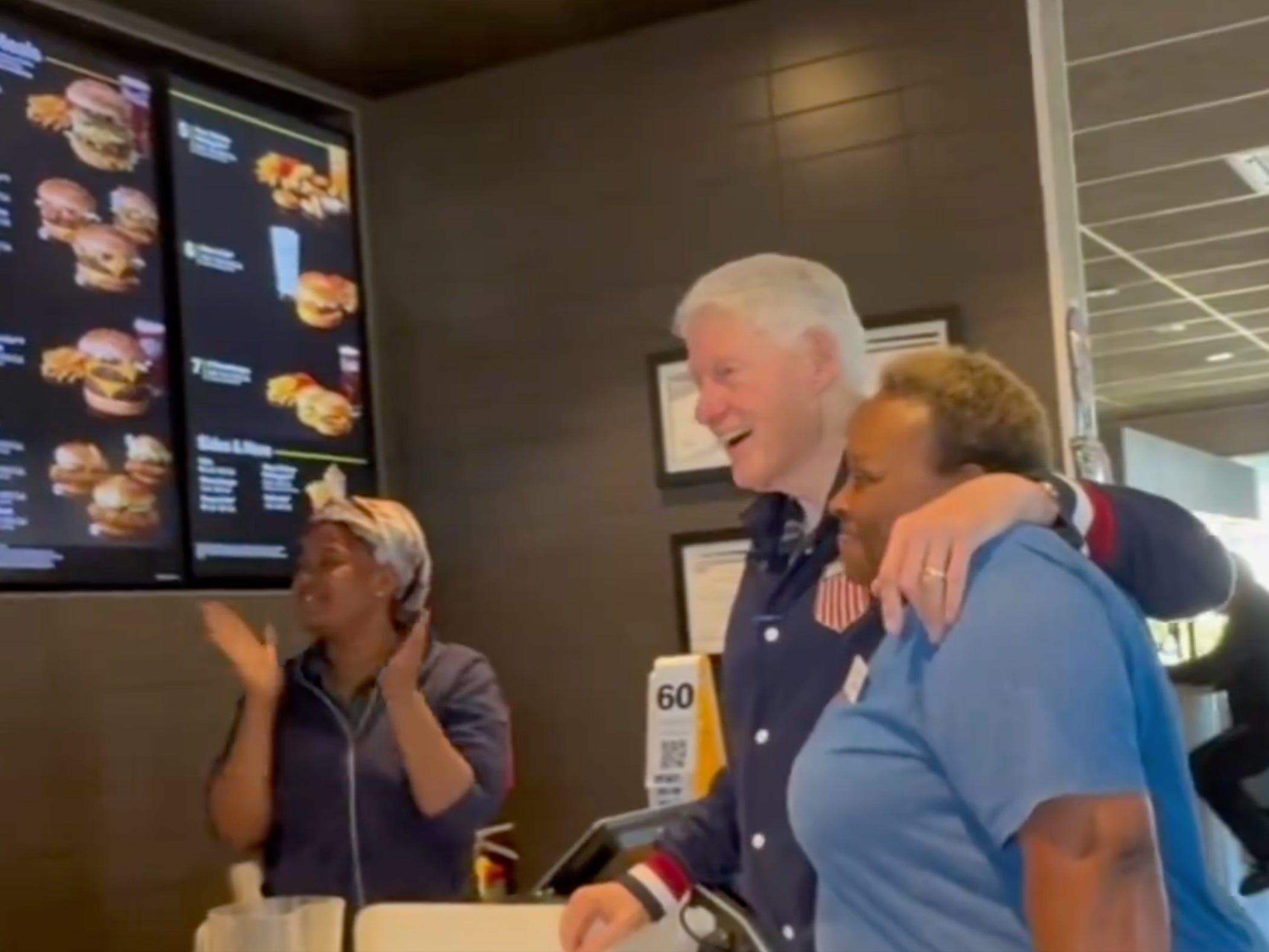 Former President Bill Clinton poses with a worker during a breakfast stop at a McDonald’s in Georgia while he was campaigning for Vice President Kamala Harris