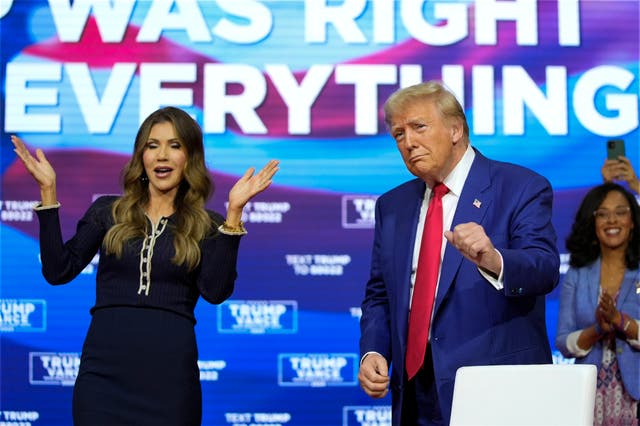 <p>South Dakota Gov. Kristi Noem dances with Republican presidential nominee Donald Trump during a town hall. Most of the event was Trump standing around after a Q&A was derailed by people falling ill </p>