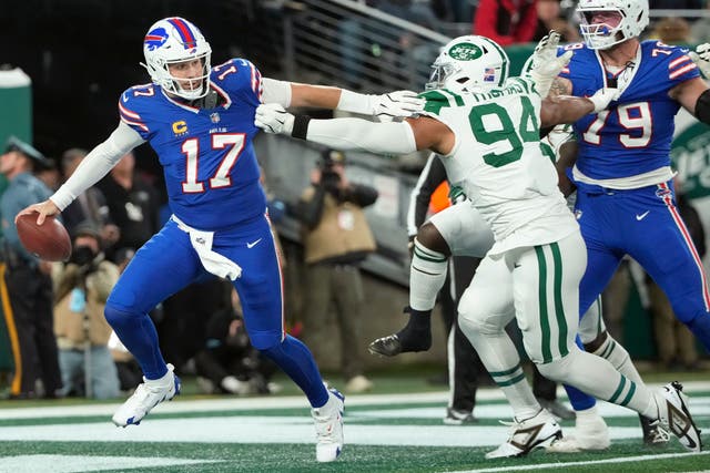 Buffalo Bills quarterback Josh Allen scrambles away from New York Jets defensive end Solomon Thomas (Pamela Smith/AP)