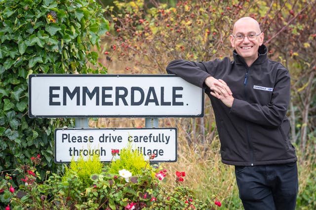 <p>Steve Marshall next to the Emmerdale sign</p>