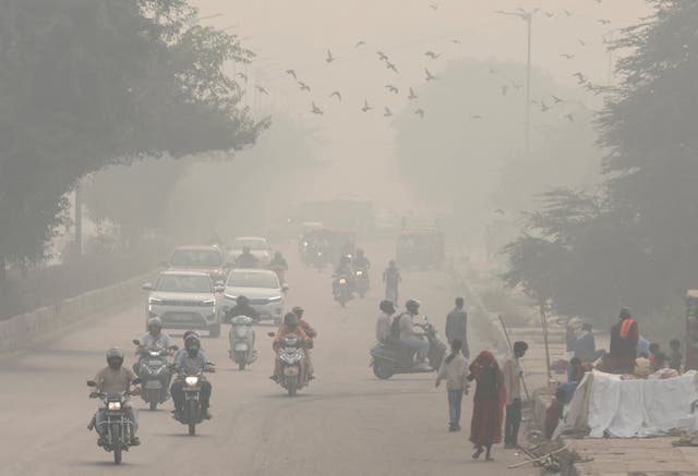 <p>File: People and vehicles are seen on a road amidst the morning smog in New Delhi, India, 8 November 2023 </p>