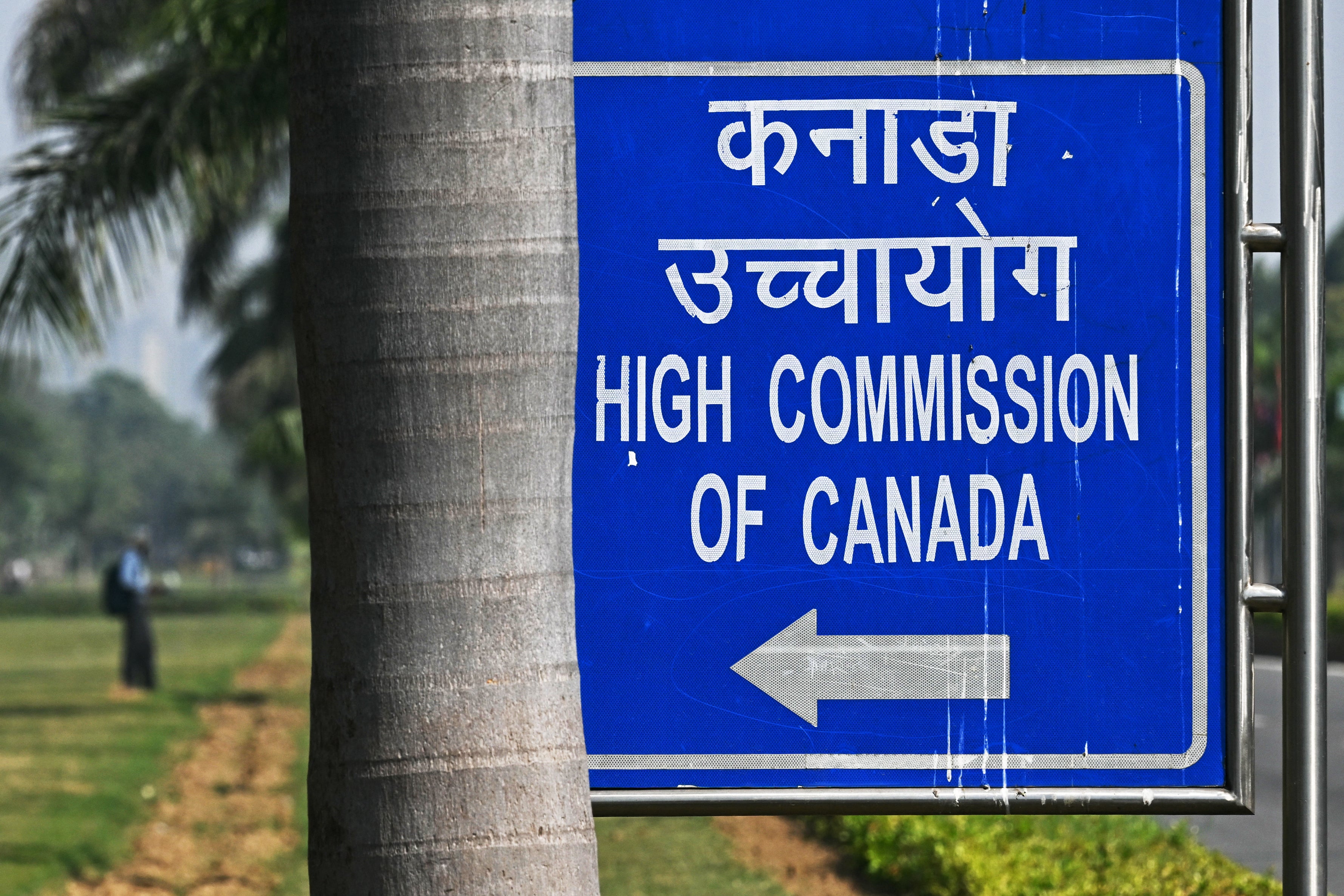 A man stands in the lawns outside the Canadian High Commission, in New Delhi on October 15, 2024. India and Canada each expelled the other's ambassador and five other top diplomat