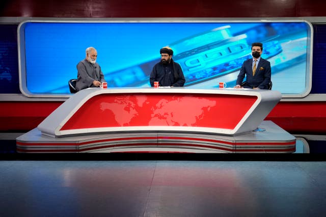 <p>TV anchor Nesar Nabil wears a face mask to protest the Taliban's new order that female presenters cover their faces, as he reads the news on TOLOnews, in Kabul, Afghanistan, Sunday, May 22, 2022</p>