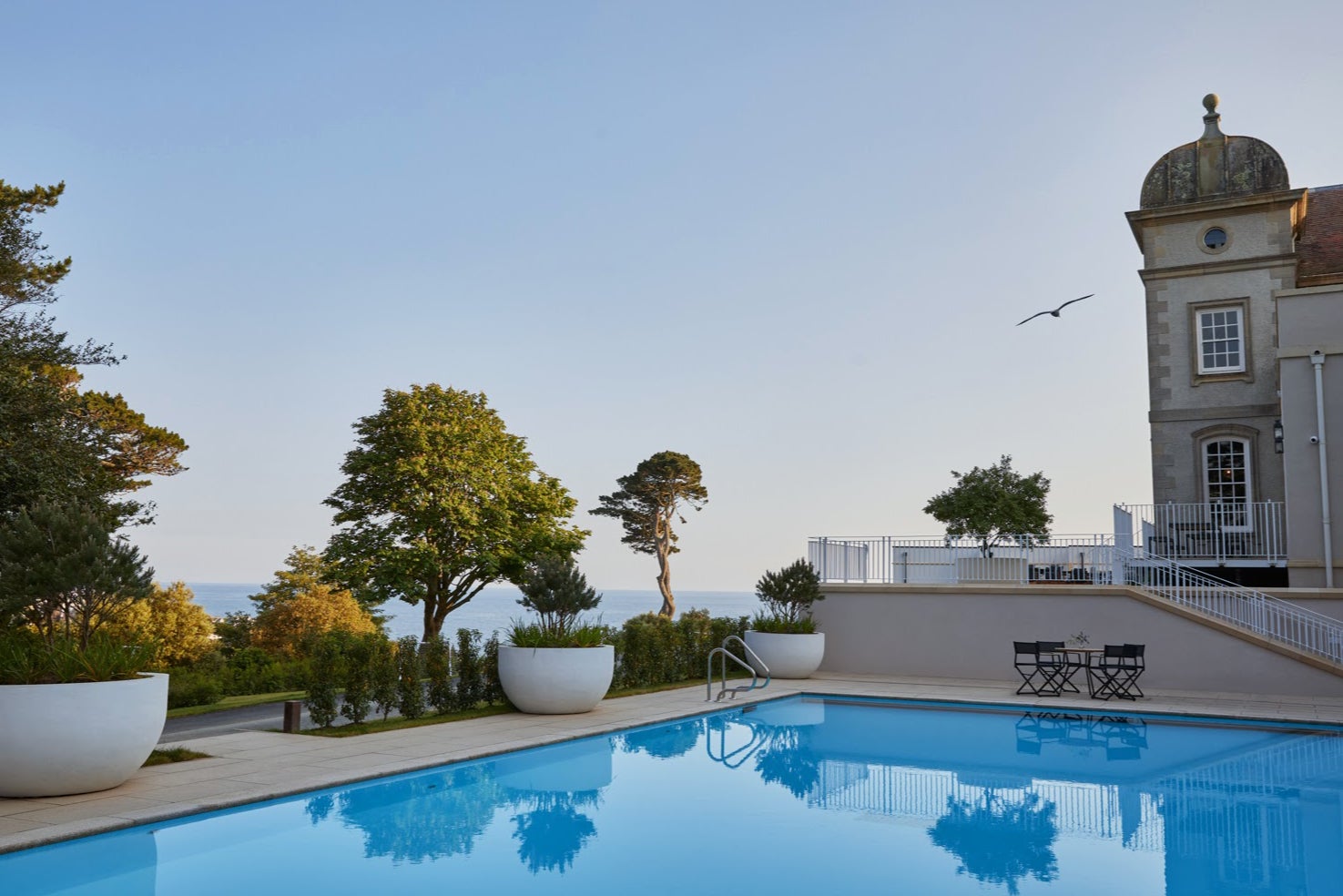 An outdoor pool provides panoramic views of the ocean