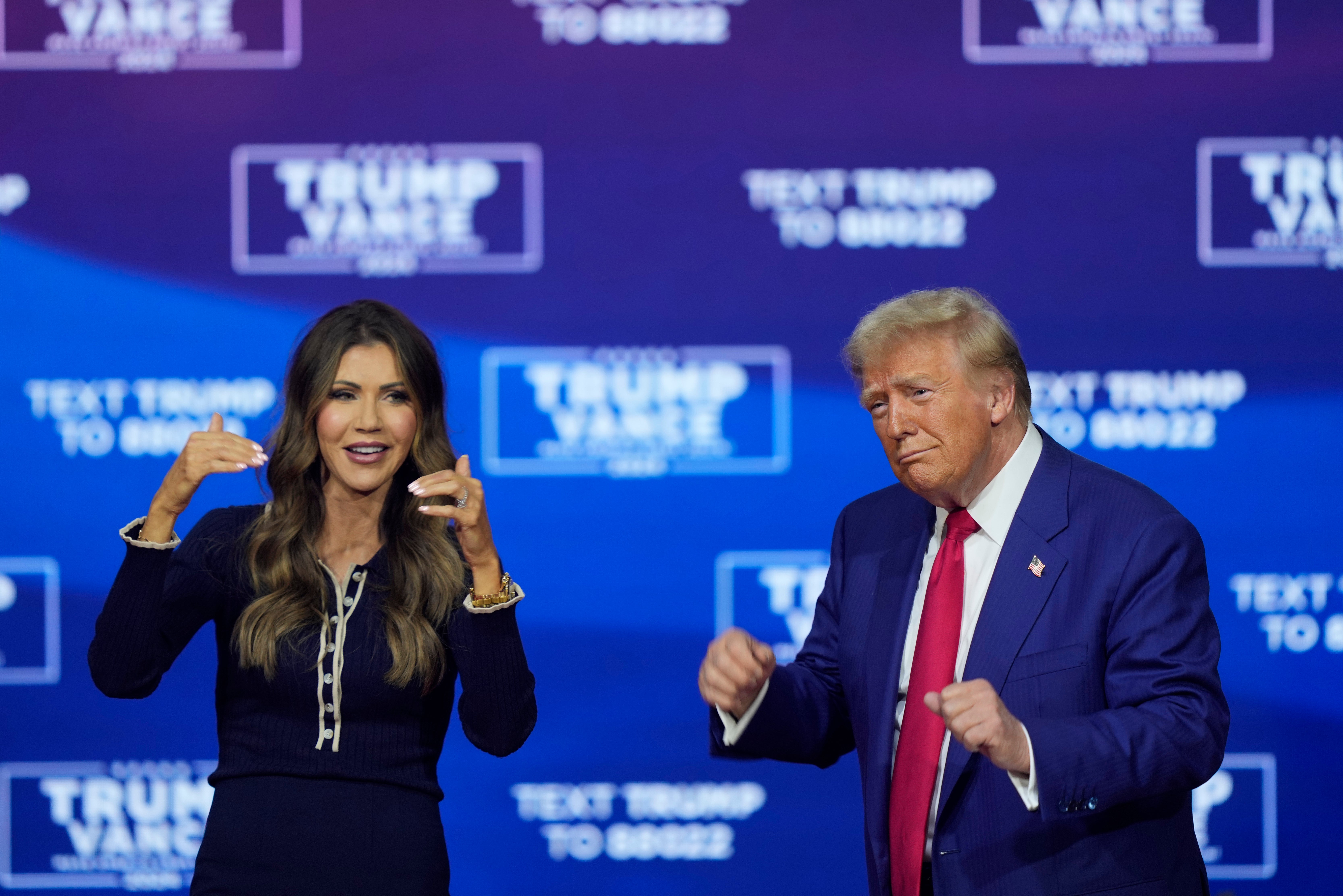 Republican presidential nominee former President Donald Trump and South Dakota Governor Kristi Noem dance to the song “Y.M.C.A.” at a campaign town hall at the Greater Philadelphia Expo Center & Fairgrounds on 14 October 2024