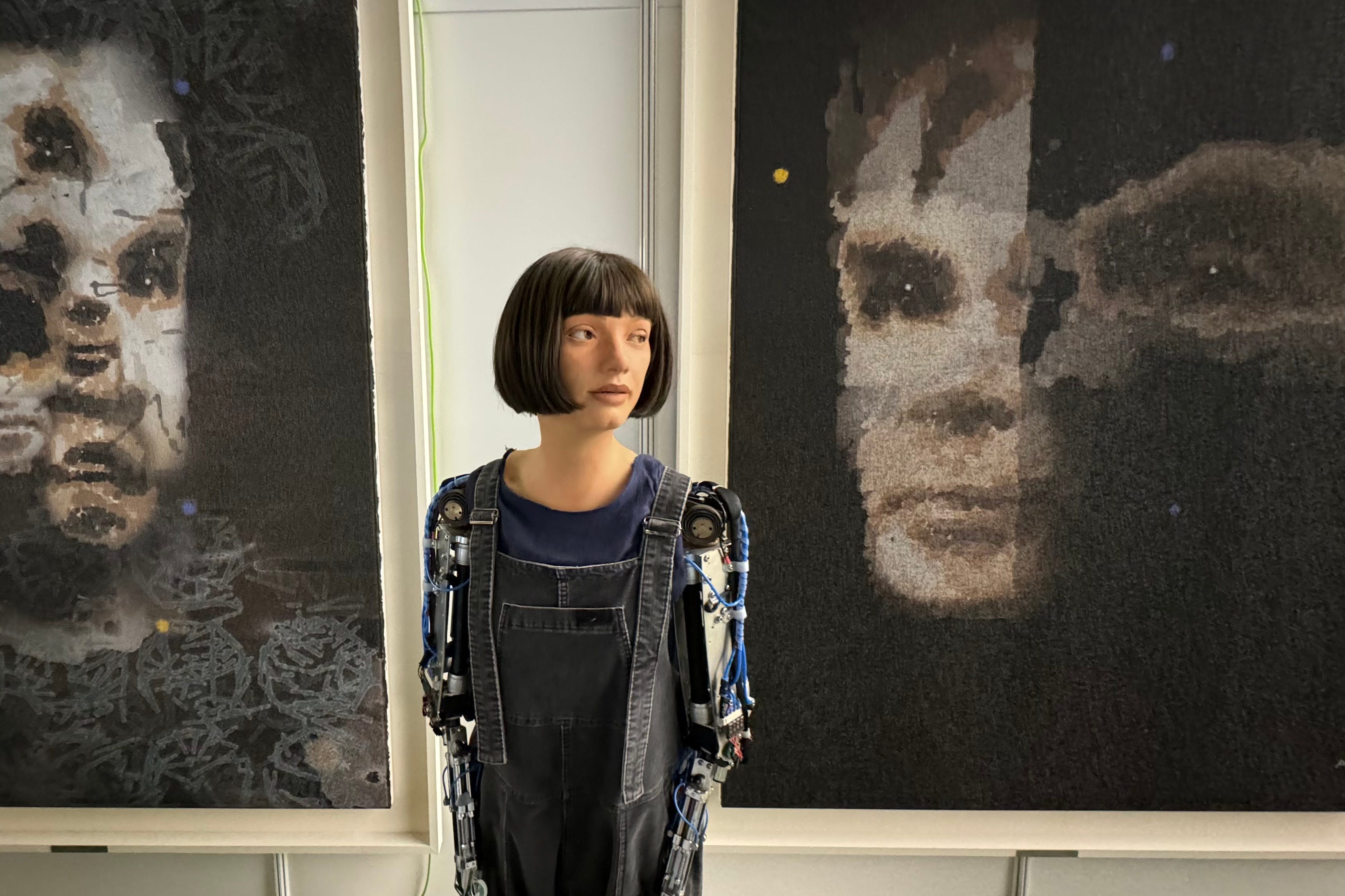 Ai-Da with the Alan Turing portrait (Ai-Da Robot Studio/PA)