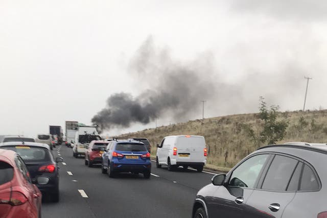 A plume of smoke rises from the scene of the crash on the M6 (chris isles/@Islesy123/PA)