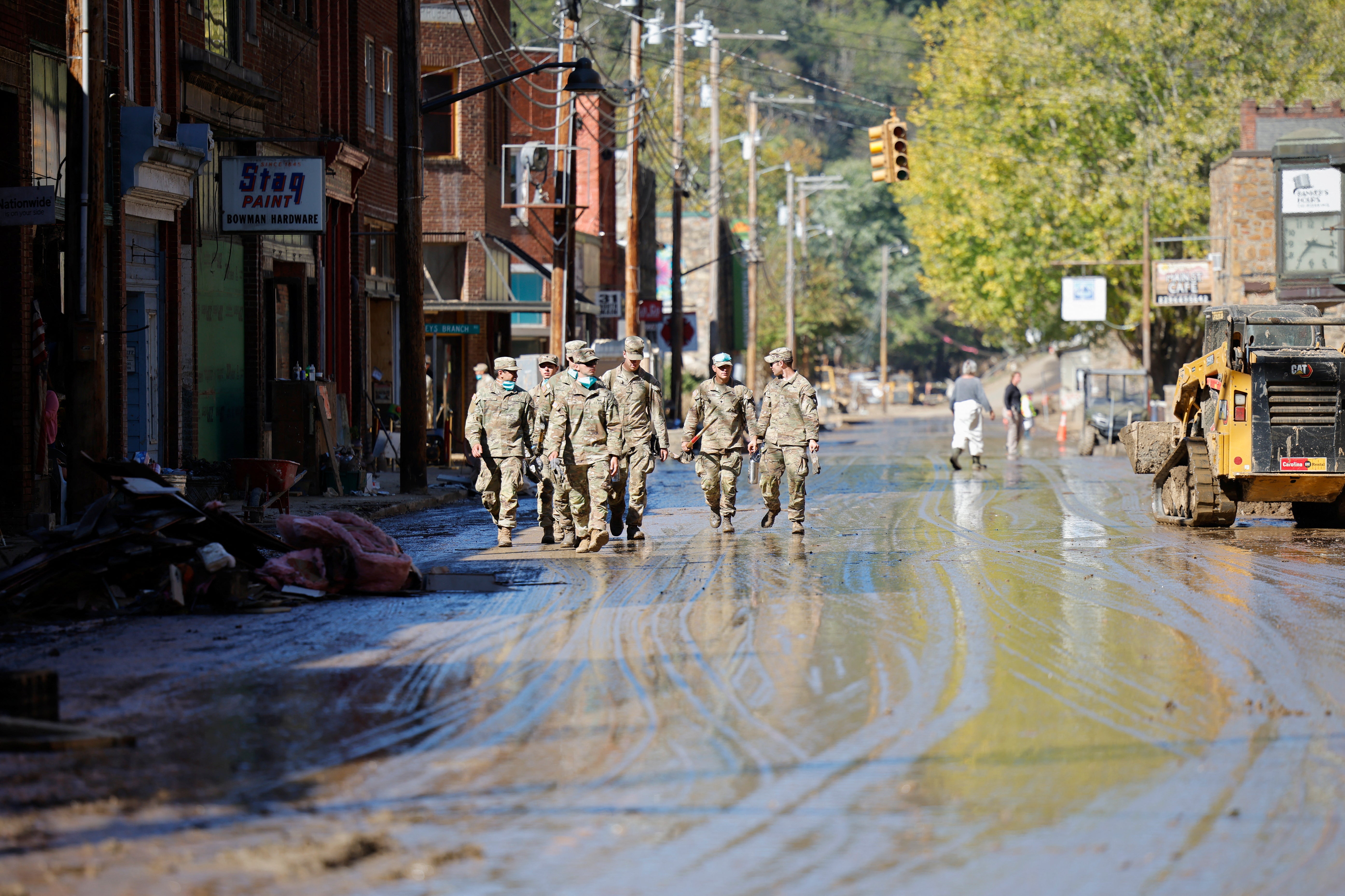 US Army infantry soldiers from the 101st Airborne Division walk down Main Street last week in Marshall, North Carolina. Recovery and relief efforts are continuing in the Tar Heel State weeks after Hurricane Helene struck the Southeast, bringing record rainfall, flooding, and landslides. As of Wednesday, 89 people were still reported as missing following the storm.