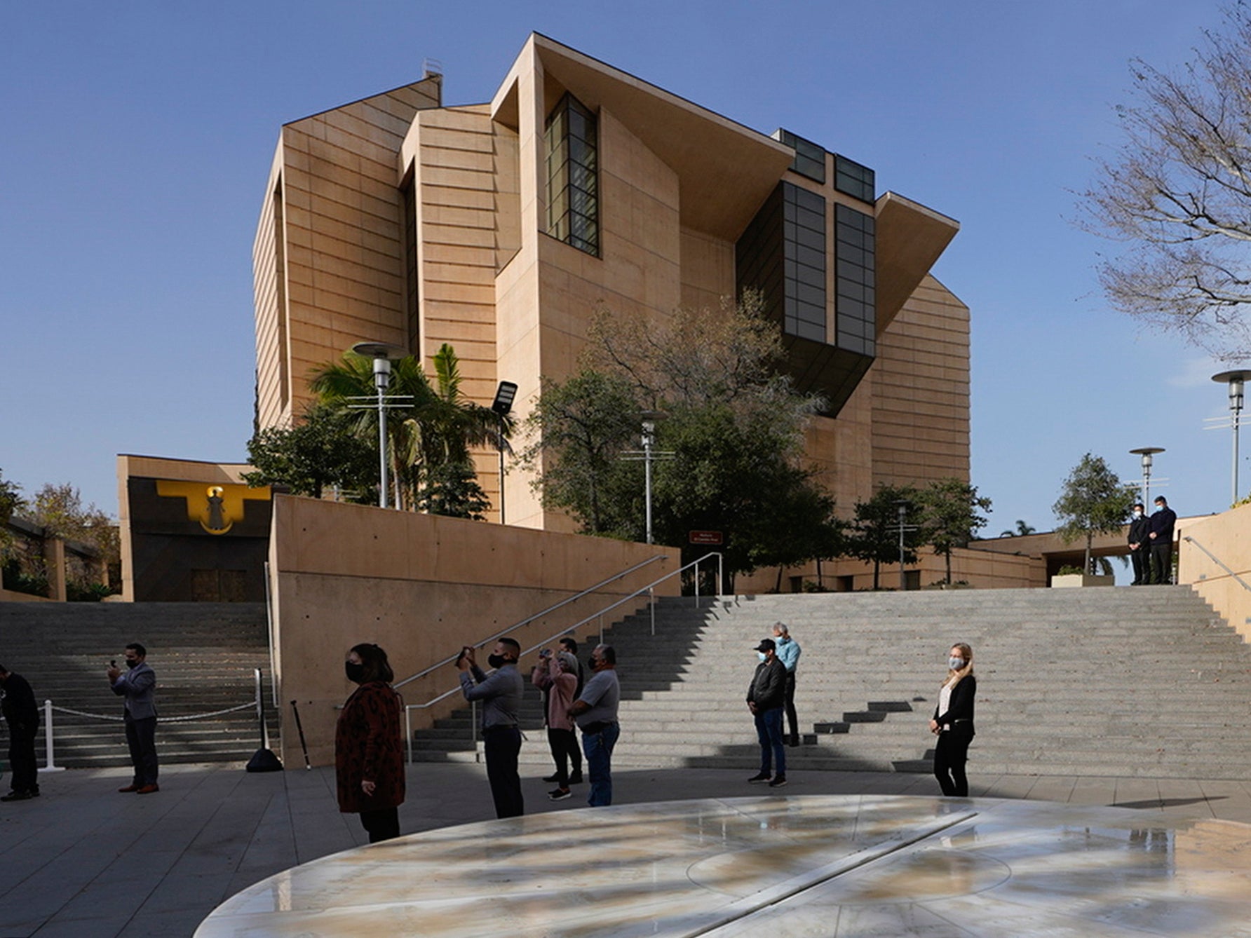 People attend a memorial service outside the Cathedral of Our Lady of Angels in Los Angeles