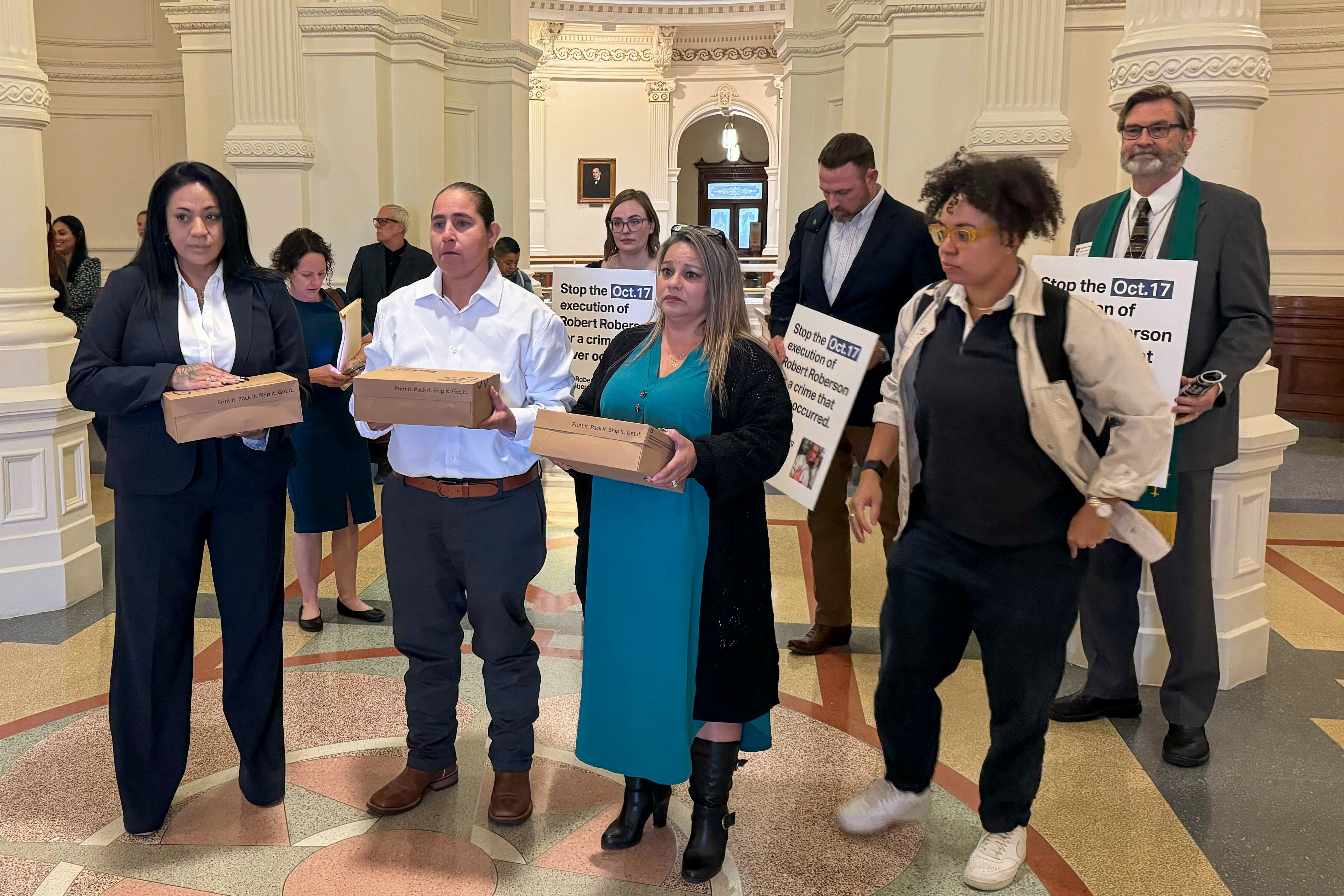 Advocates deliver boxes of petitions to Texas Governor Greg Abbott’s office a day before Roberson’s scheduled execution