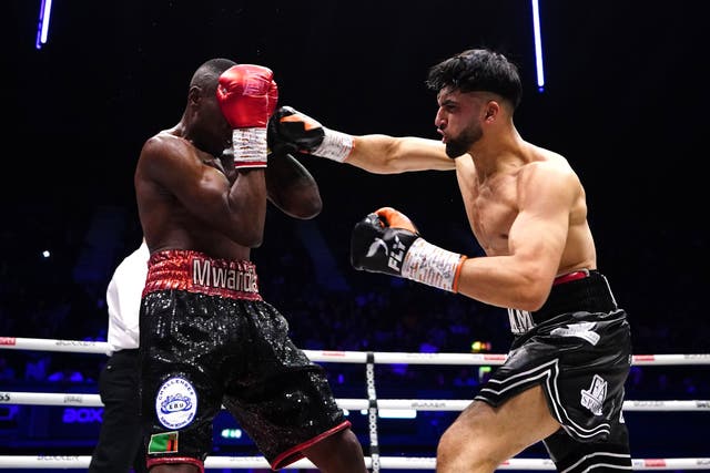 Adam Azim, right, hopes to inspire British Asians inside and outside the ring (Zac Goodwin/PA)