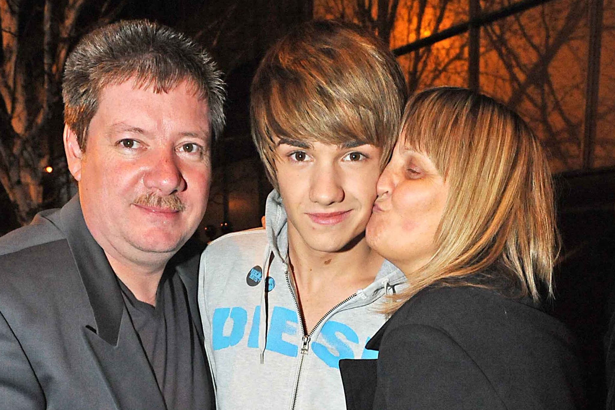 Payne with his parents Geoff and Karen after the X Factor final in 2010