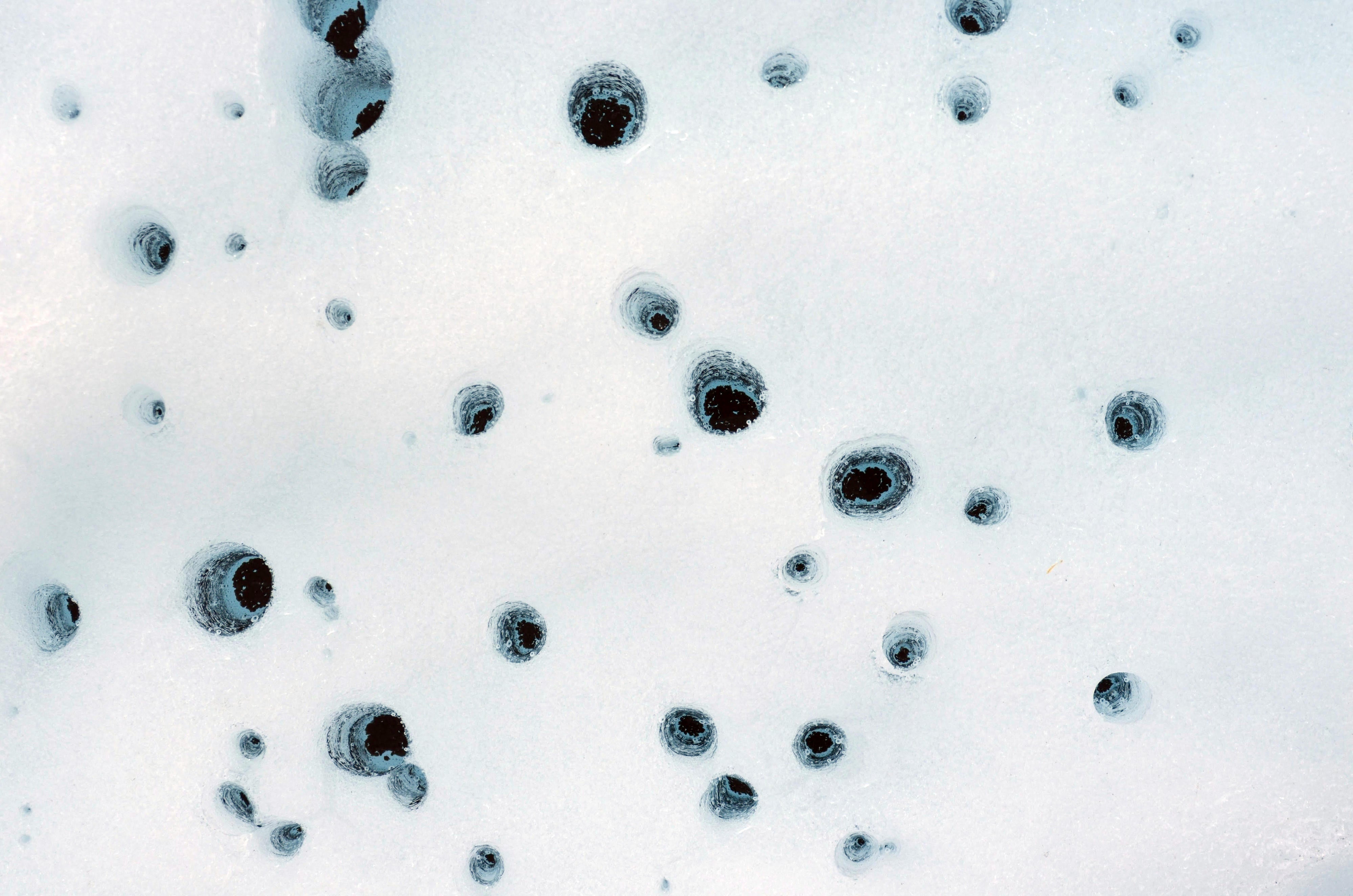 Holes formed by cryoconite on Alaska’s Matanuska Glacier in 2012. Cryoconite consists of dust particles that melt into the ice over time, eventually forming small pockets of water below the glacier’s surface. Scientists believe similar pockets of water could form within dusty water ice on Mars