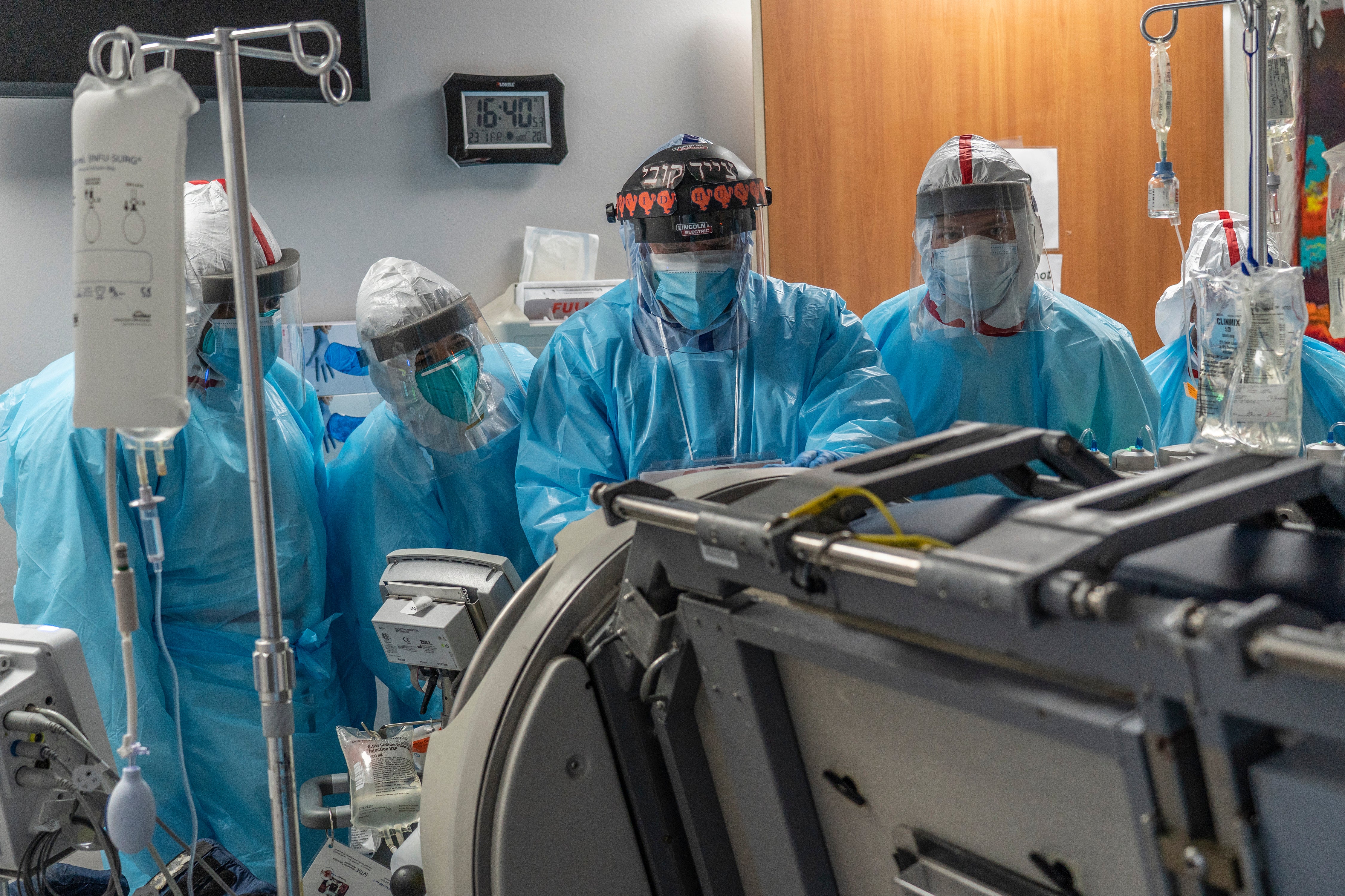 Medical staff members listen while a doctor operates a Roto-prone bed in a patient’s room in the COVID-19 intensive care unit (ICU) at the United Memorial Medical Center in 2020. A Kentucky man’s organs were almost harvested, but then he showed signs of life.