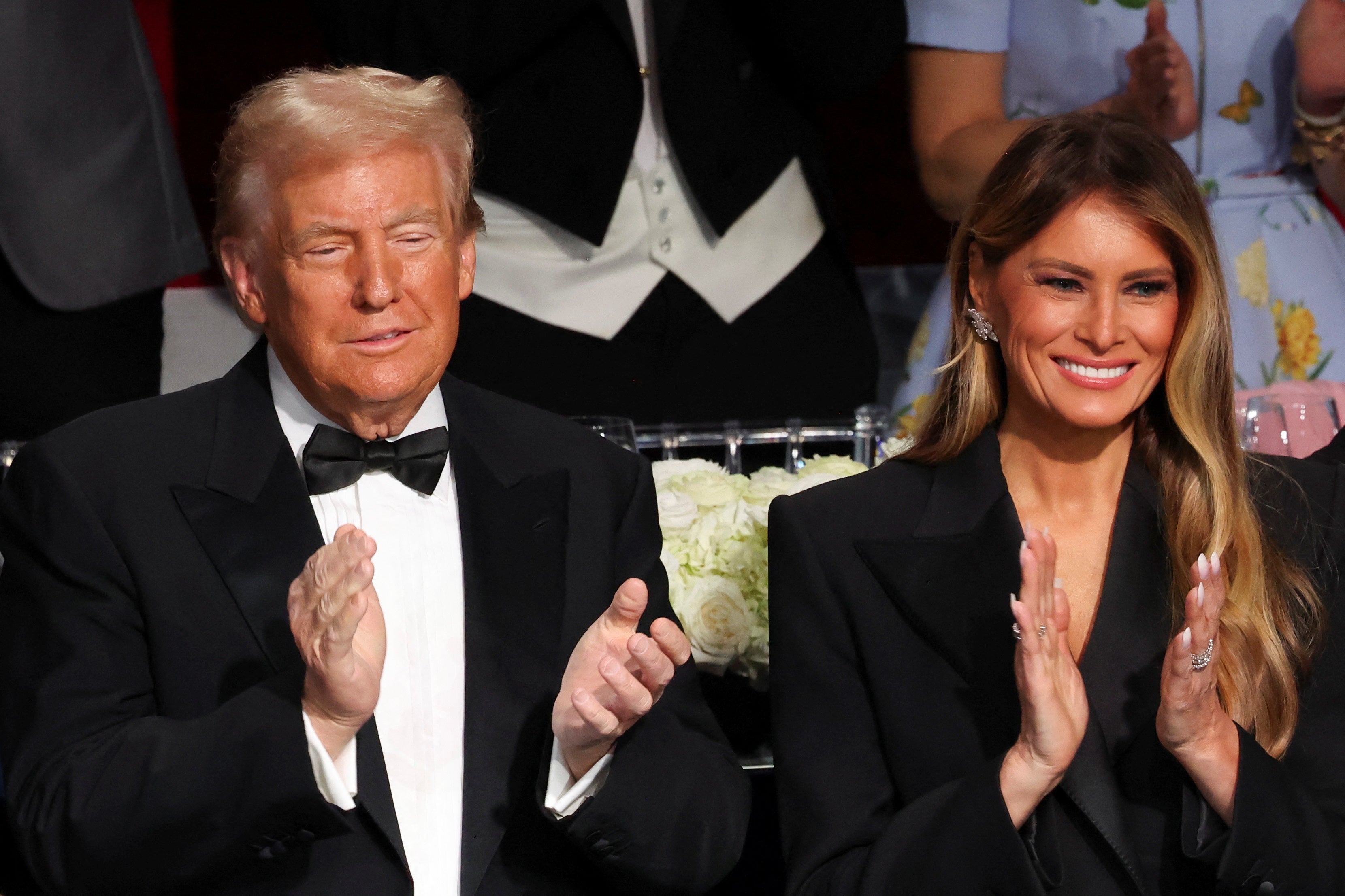 Donald and Melania Trump smile and clap at the Al Smith charity dinner in New York City on Thursday night