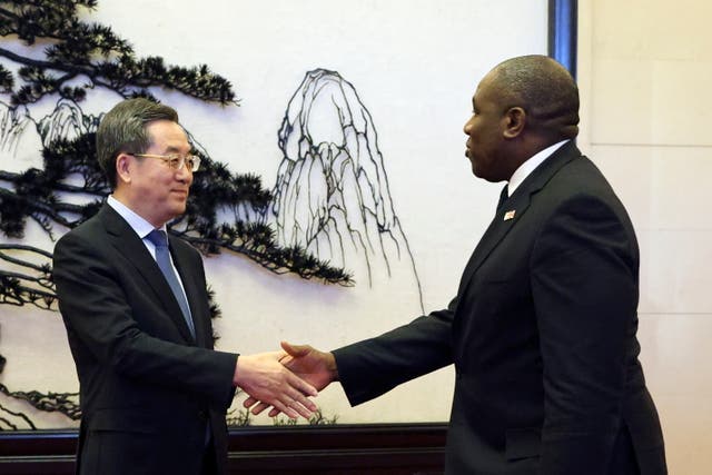 <p>Britain's Foreign Secretary David Lammy and Chinese Vice Premier Ding Xuexiang shake hands before their meeting at the Great Hall of the People in Beijing</p>