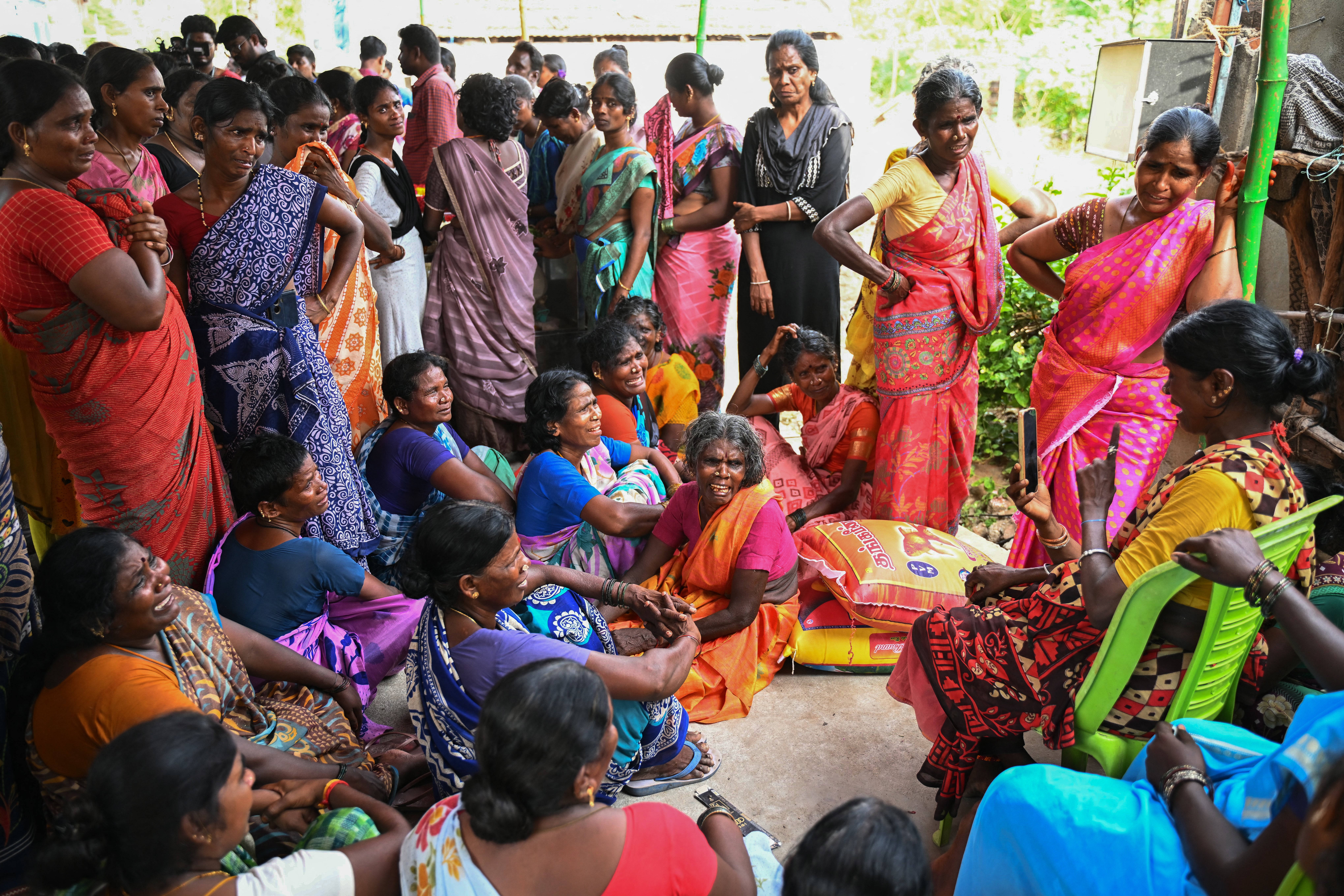 File. Relatives weep next to dead bodies of victims who died after consuming toxic alcohol in Tamil Nadu, India, on 20 June 2024