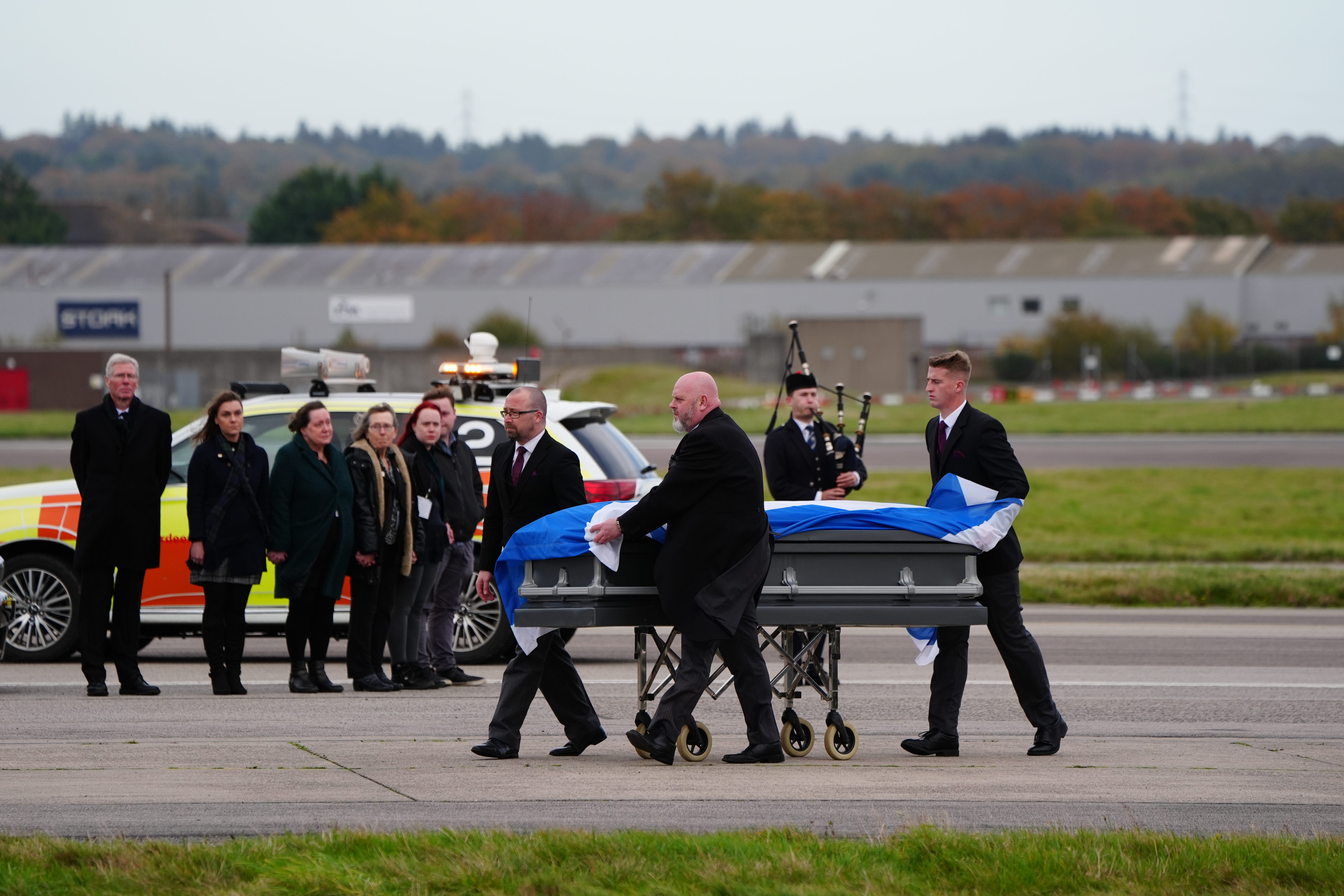 The former first minister’s Saltire-draped coffin landed in Aberdeen just before 2pm (Jane Barlow/PA)