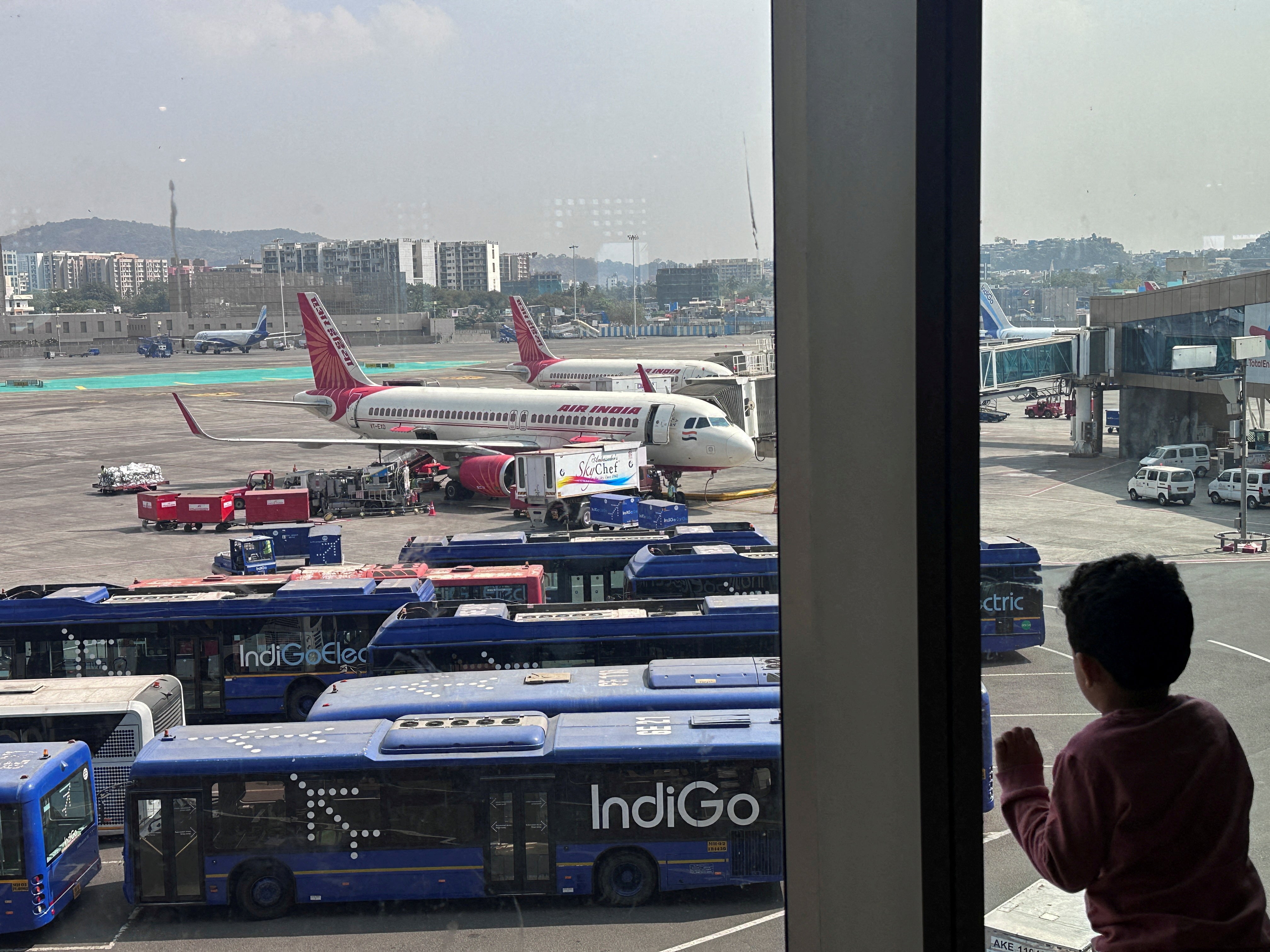 <p>File: A boy looks at Air India airline passenger aircrafts parked at the Chhatrapati Shivaji Maharaj International Airport in Mumbai, India, 1 February 2024</p>