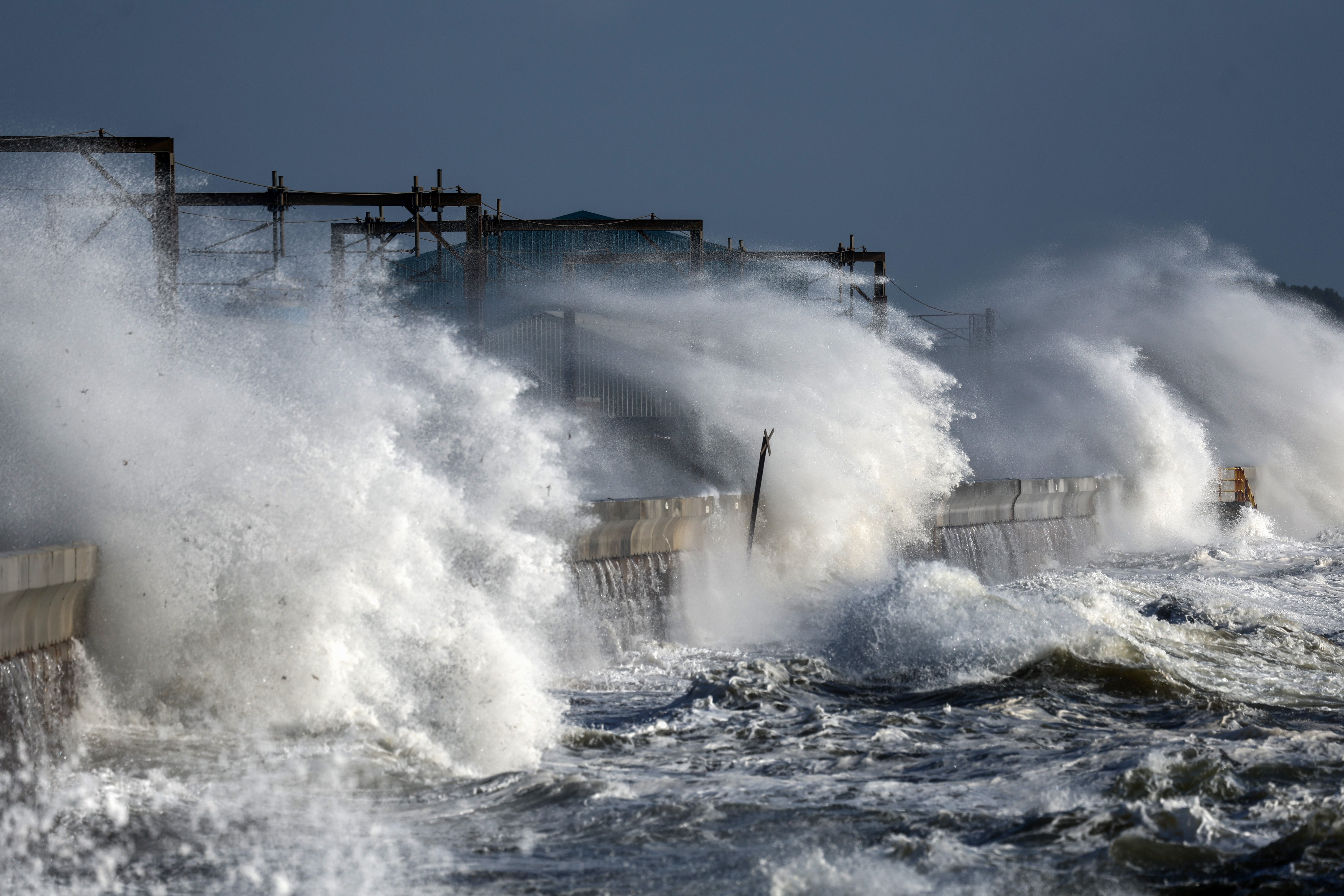 Waves crash against the sea defences in Saltcoats, Scotland