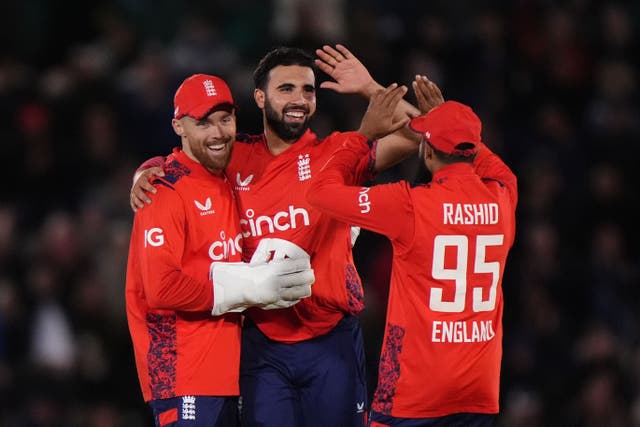 Saqib Mahmood, centre, insisted playing for England remains his top priority (Bradley Collyer/PA)