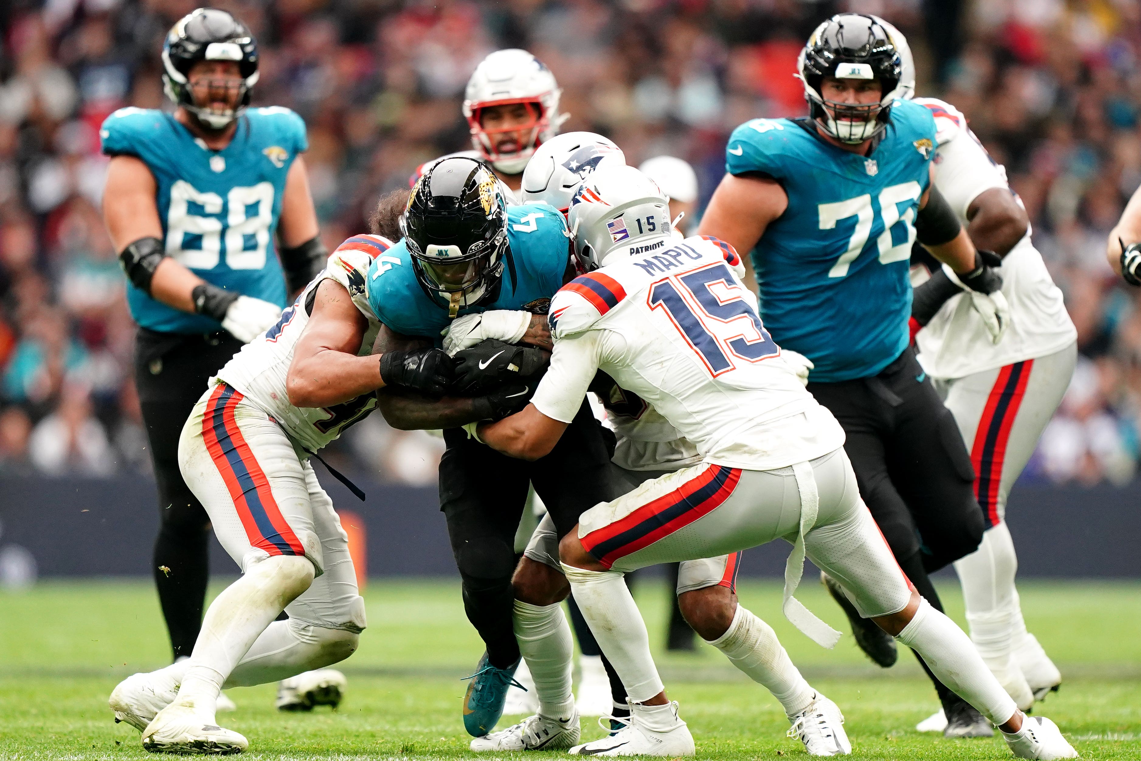 New England Patriots’ Marte Mapu (right) and Jacksonville Jaguars’ Tank Bigsby battle for the ball (Zac Goodwin/PA)