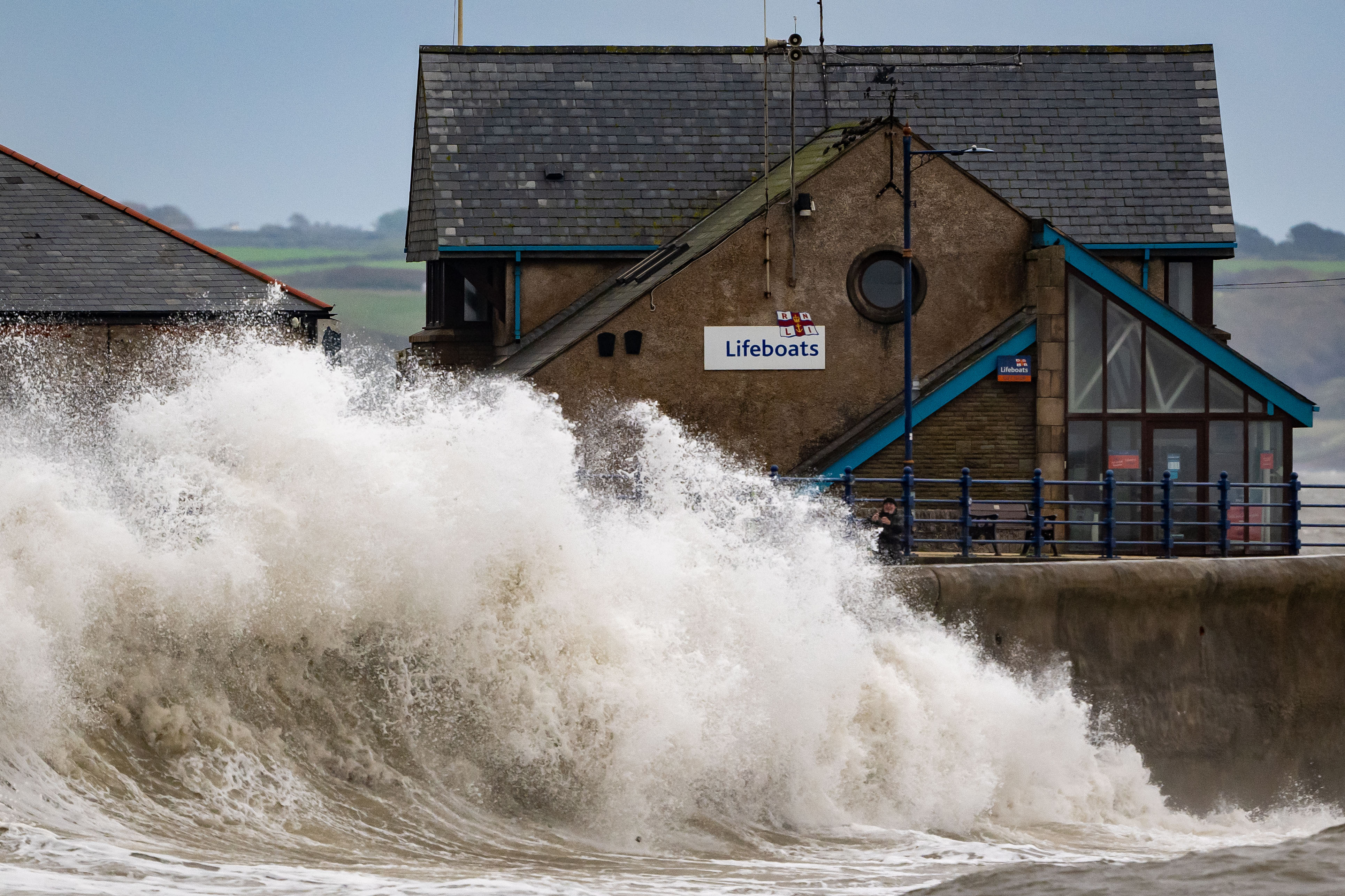 Waves crash against the harbour wall during Storm Ashley in Porthcawl, Wales, on Sunday