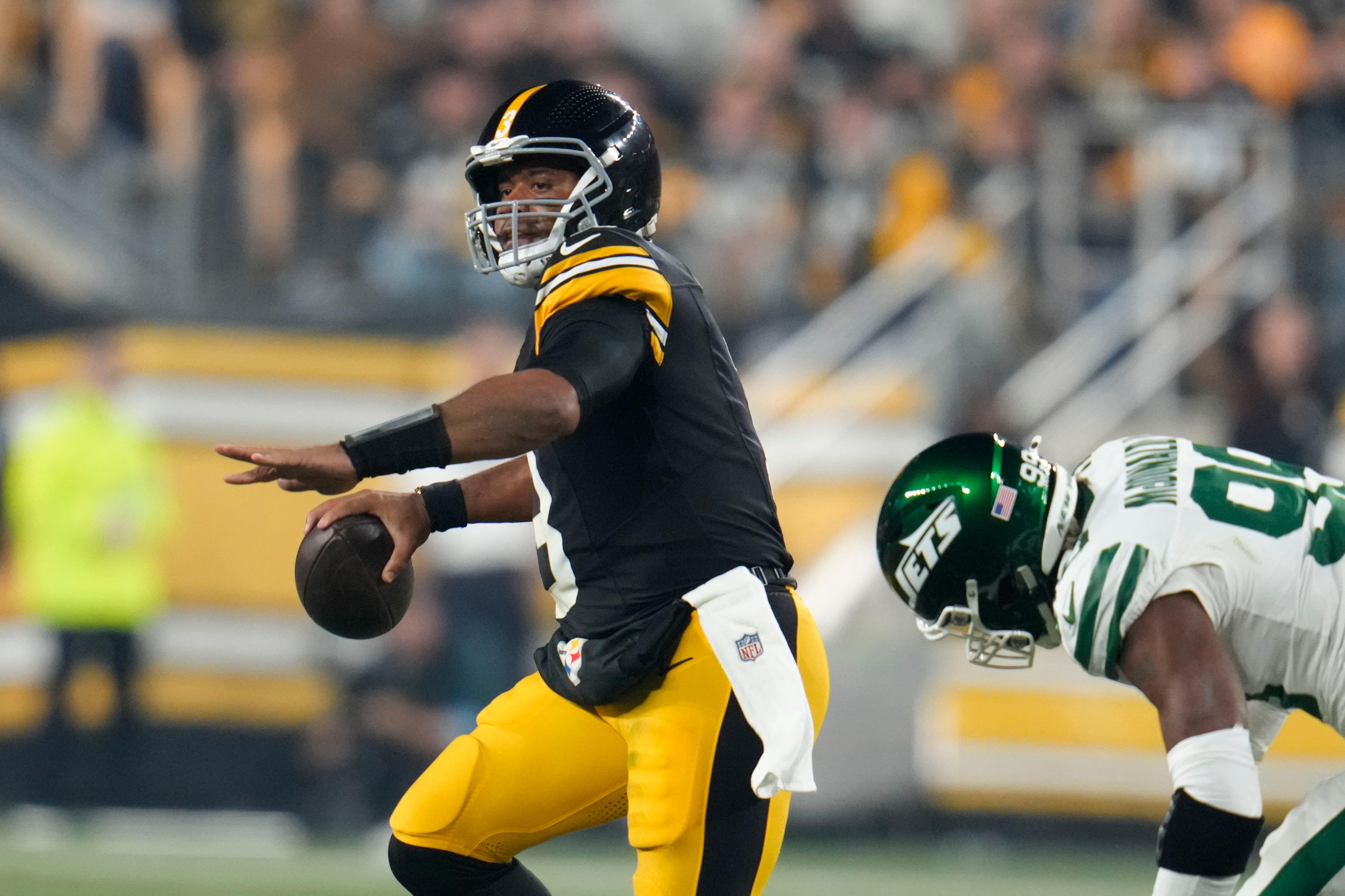 Pittsburgh Steelers quarterback Russell Wilson scrambles from New York Jets defensive end Will McDonald IV (Gene J Puskar/AP)