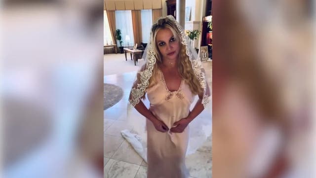 <p>Britney Spears declares she is married again as she dons wedding dress and veil.</p>