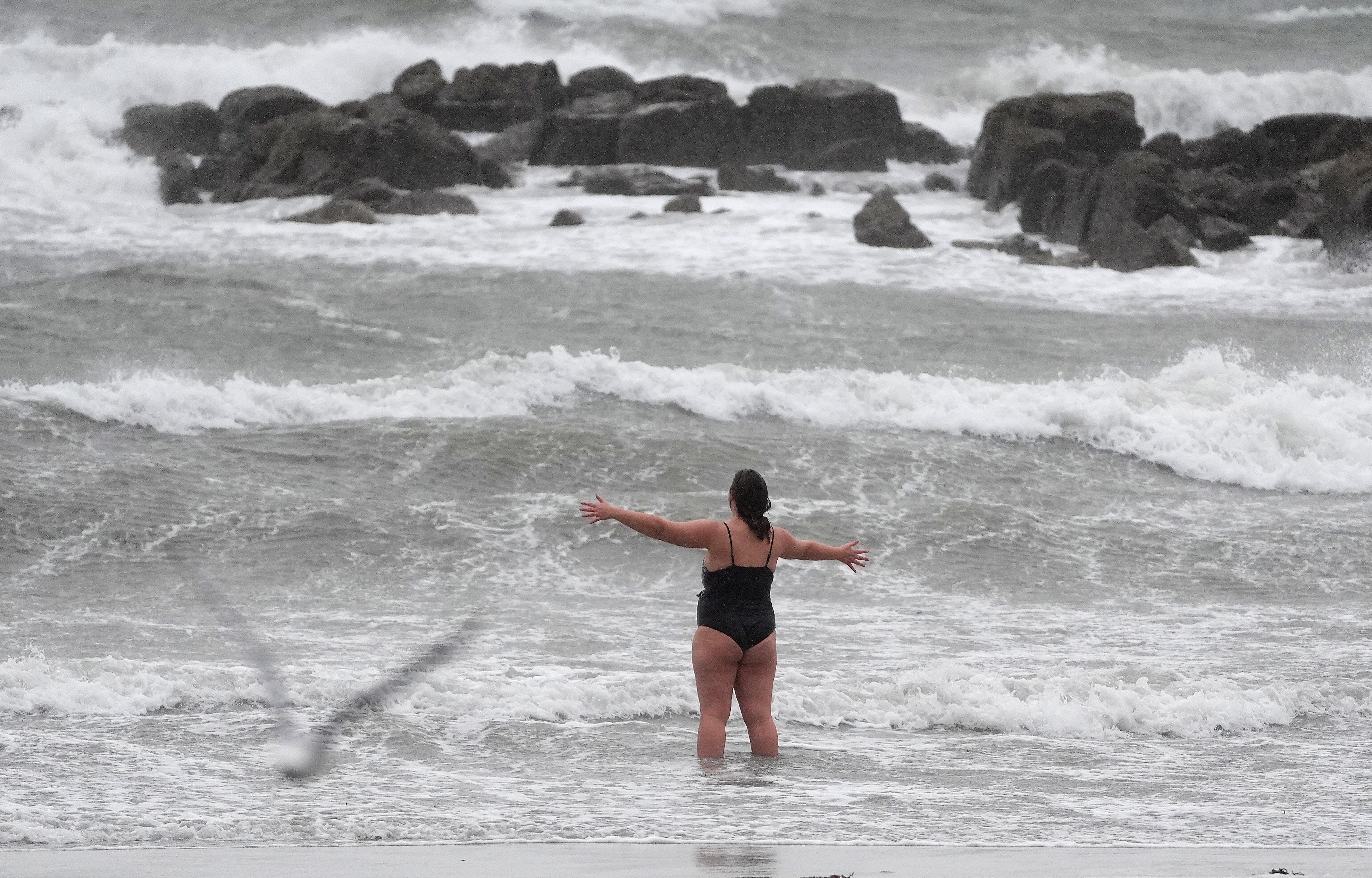 A woman braces herself for a cold swim in Salthill, Galway, during Storm Ashley