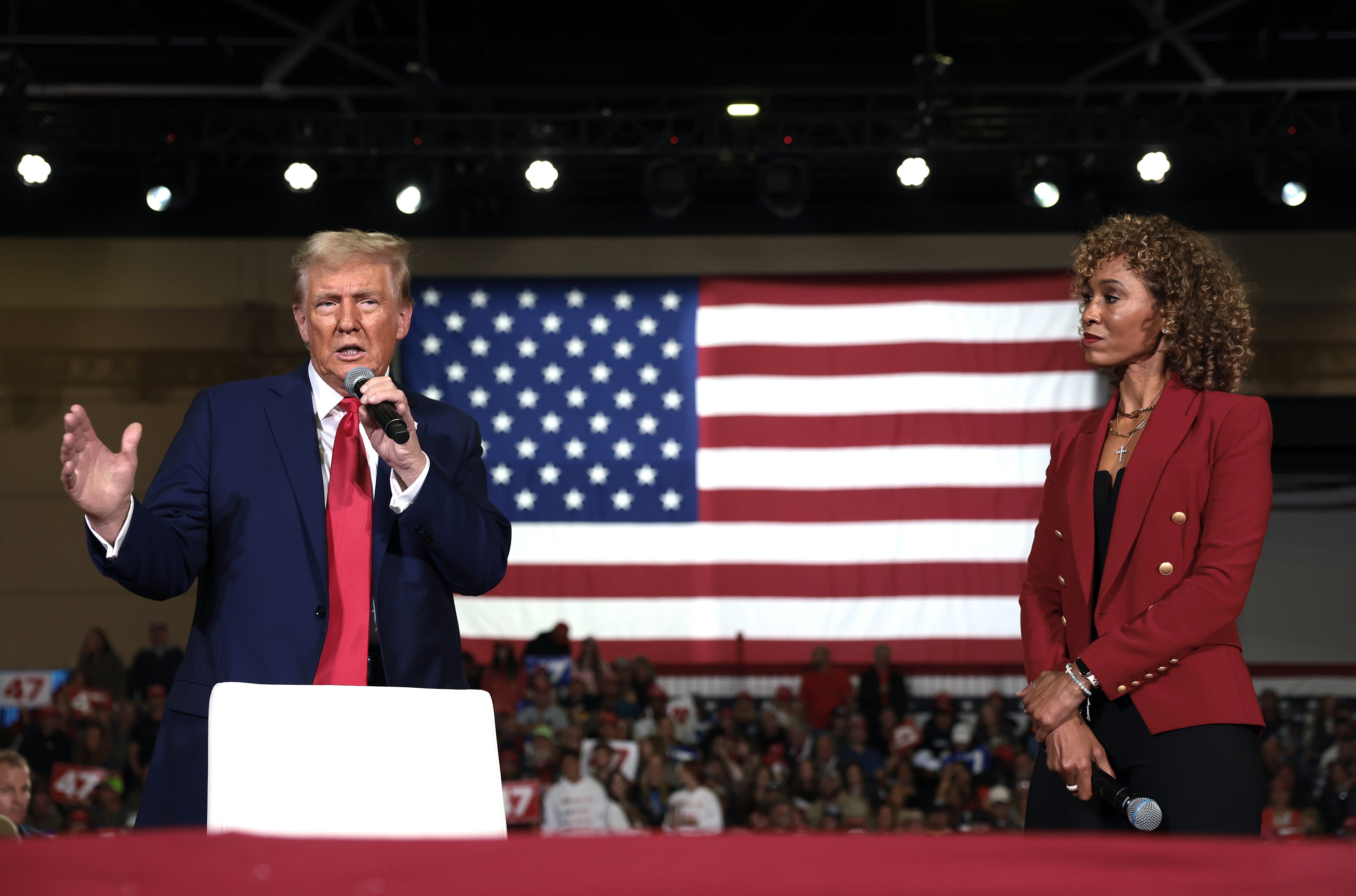 Trump speaks alongside moderator Steele during a town hall at the Lancaster County Convention Center on Sunday