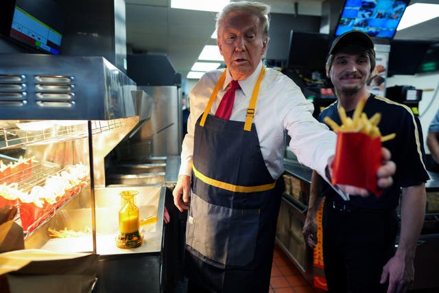 <p>Donald Trump hands over some fries while working in a McDonald’s </p>