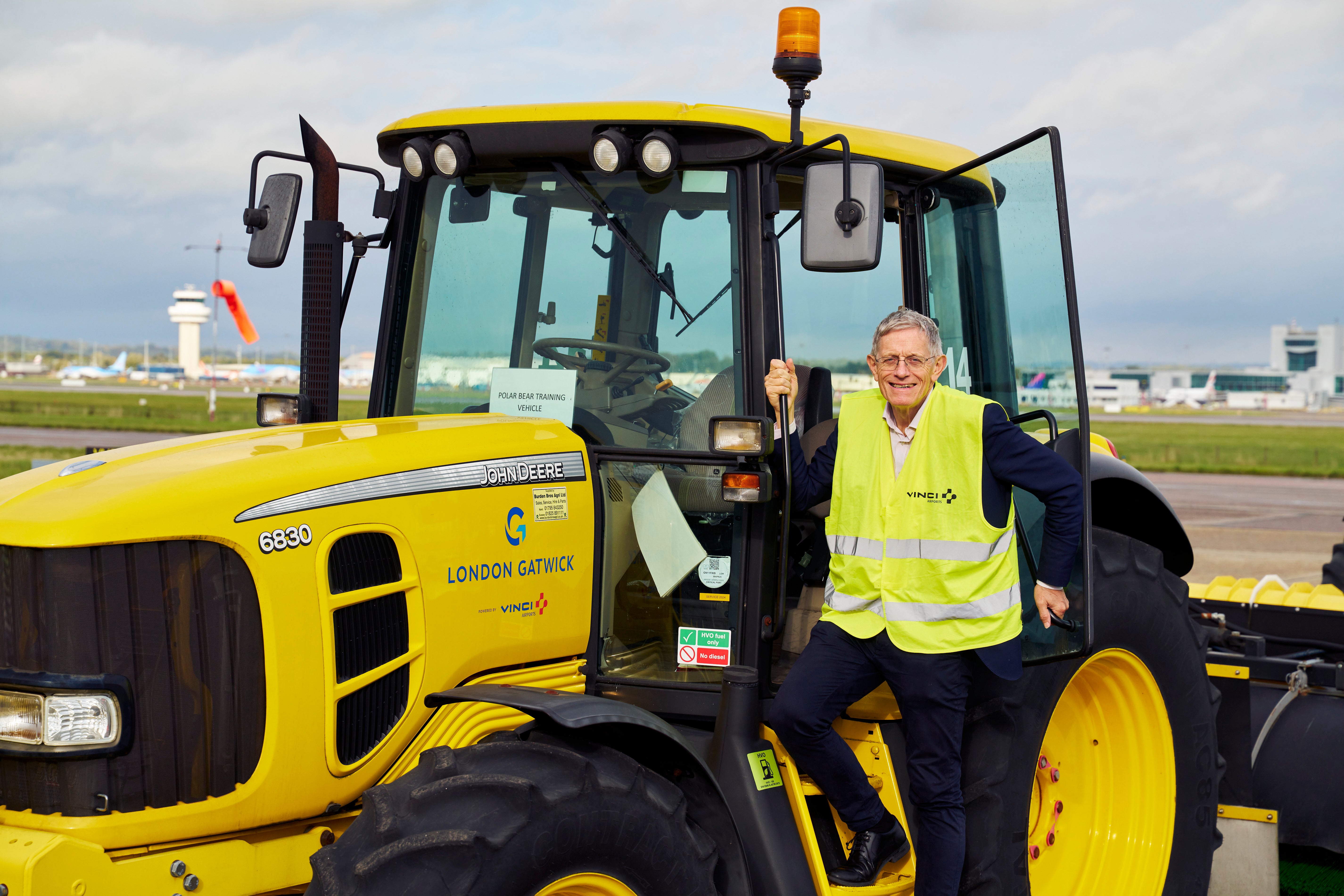 Yellow peril: Simon Calder climbing down from an Øveraasen snow plough at Gatwick airport