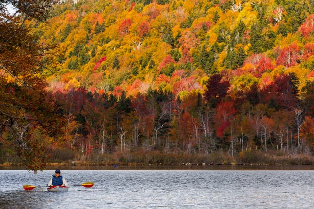 <p>New Hampshire leaves display bright colors near New Hampshire’s Echo Lake earlier this month. Warming temperatures are turning stunning fall foliage displays brown, and pushing back viewing times.  </p>